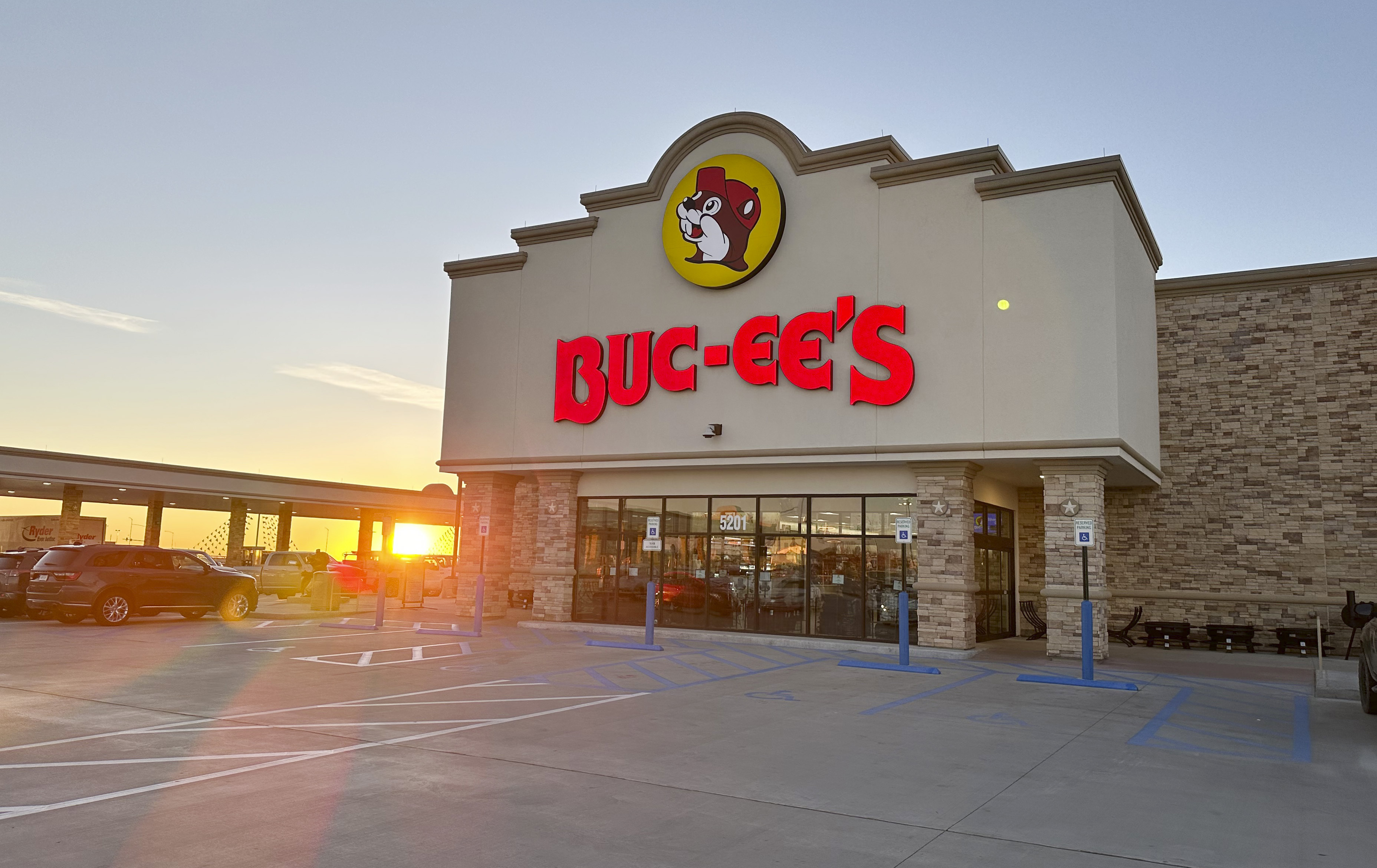 FILE - The sun rises beyond the gasoline pumps outside a Buc-ee's store on April 4, 2024, in Johnstown, Colo. (AP Photo/David Zalubowski, File)