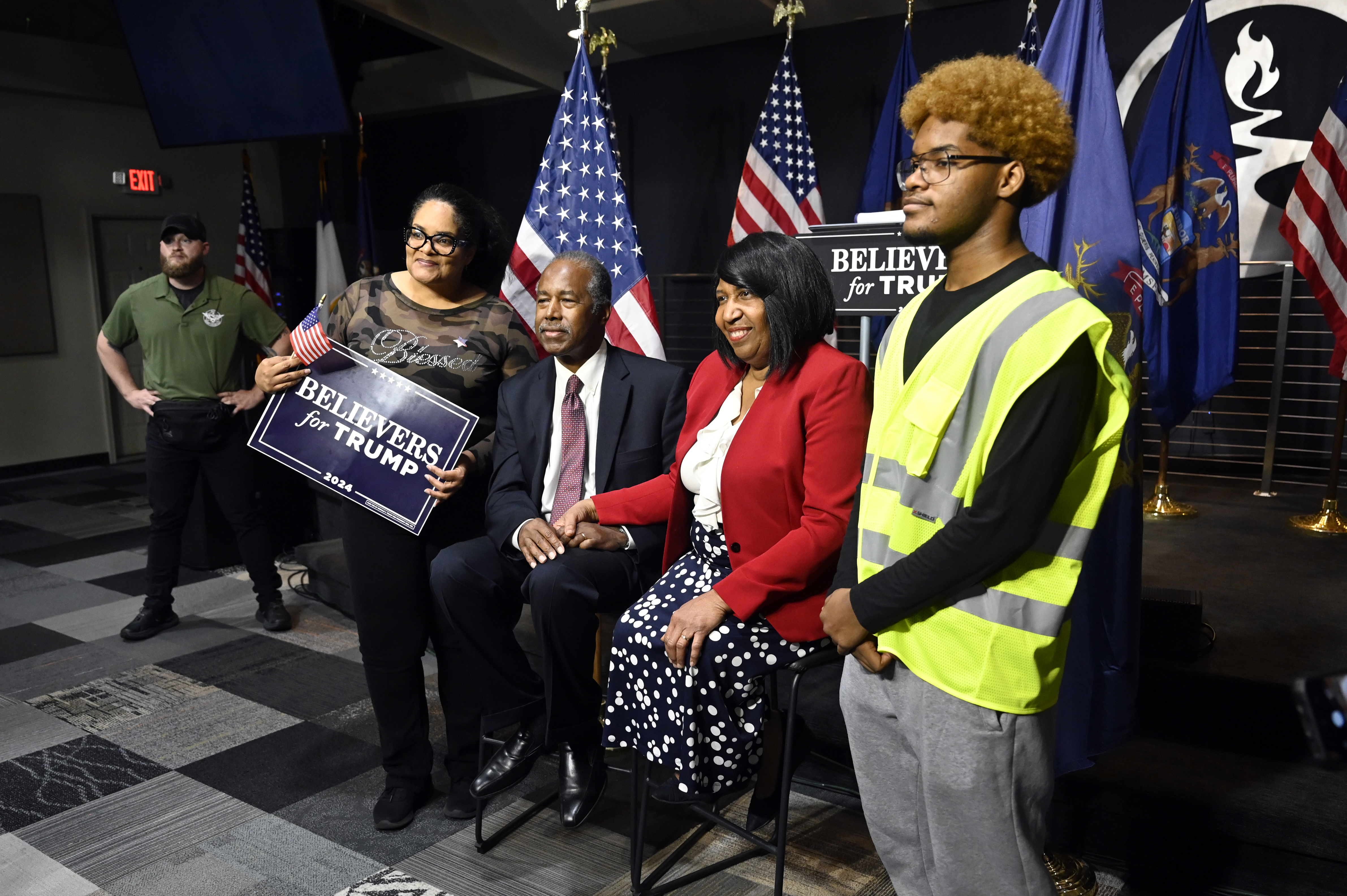 Ben Carson, center, and his wife Candy Carson, right center, pose for a photo with Tiffany King, second from left, and her son, Nehemiah King, right, following Carson's address to supporters of Republican presidential nominee former President Donald Trump, Saturday, Oct. 5, 2024, in Livonia, Mich. (AP Photo/Jose Juarez)