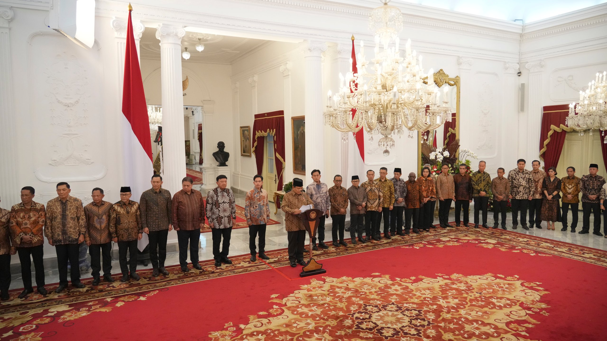 Newly appointed cabinet ministers stand behind Indonesia's new President Prabowo Subianto, center, as he announces his cabinet lineup at Merdeka Palace in Jakarta, Indonesia, Sunday, Oct. 20, 2024. (AP Photo/Achmad Ibrahim)