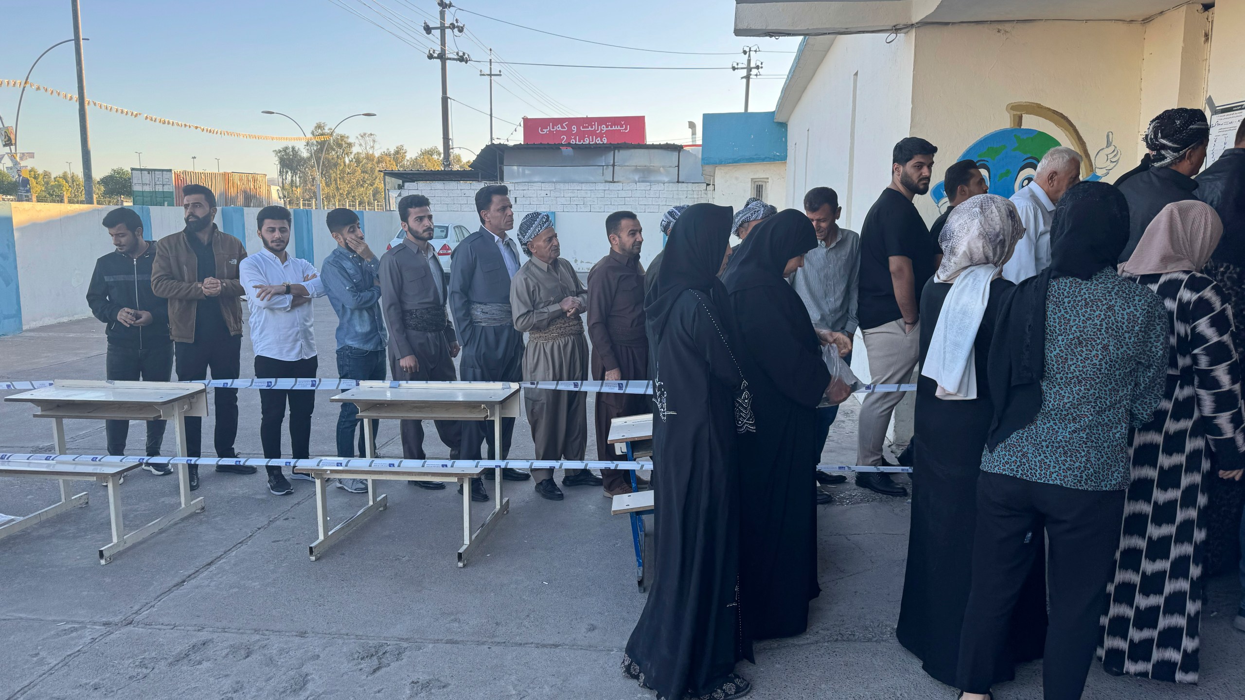 People line up to vote during parliamentary elections of Iraq’s semi-autonomous northern Kurdish region, in Irbil, Sunday, Oct. 20, 2024. (AP Photo/Salar Salim)