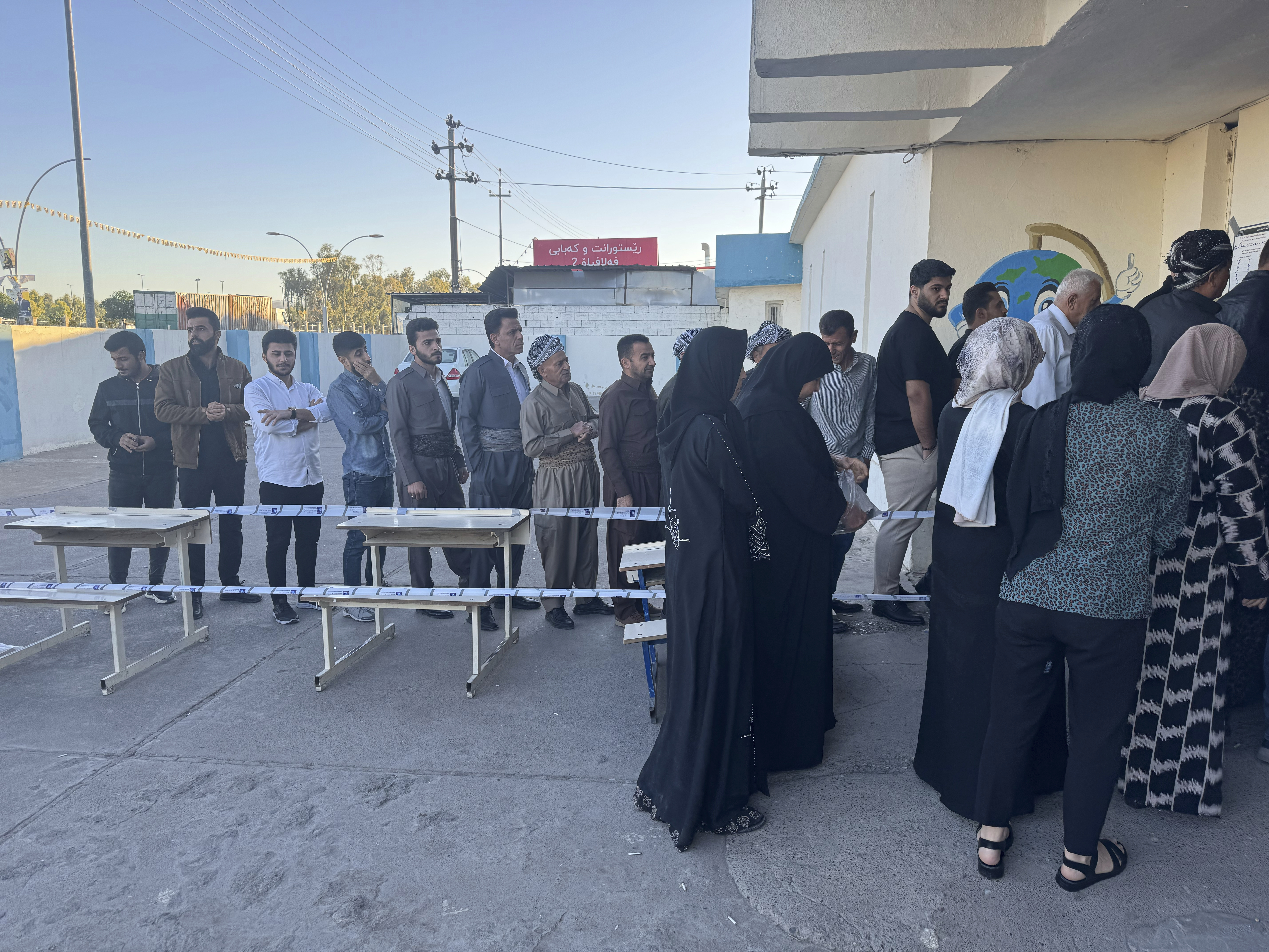 People line up to vote during parliamentary elections of Iraq’s semi-autonomous northern Kurdish region, in Irbil, Sunday, Oct. 20, 2024. (AP Photo/Salar Salim)