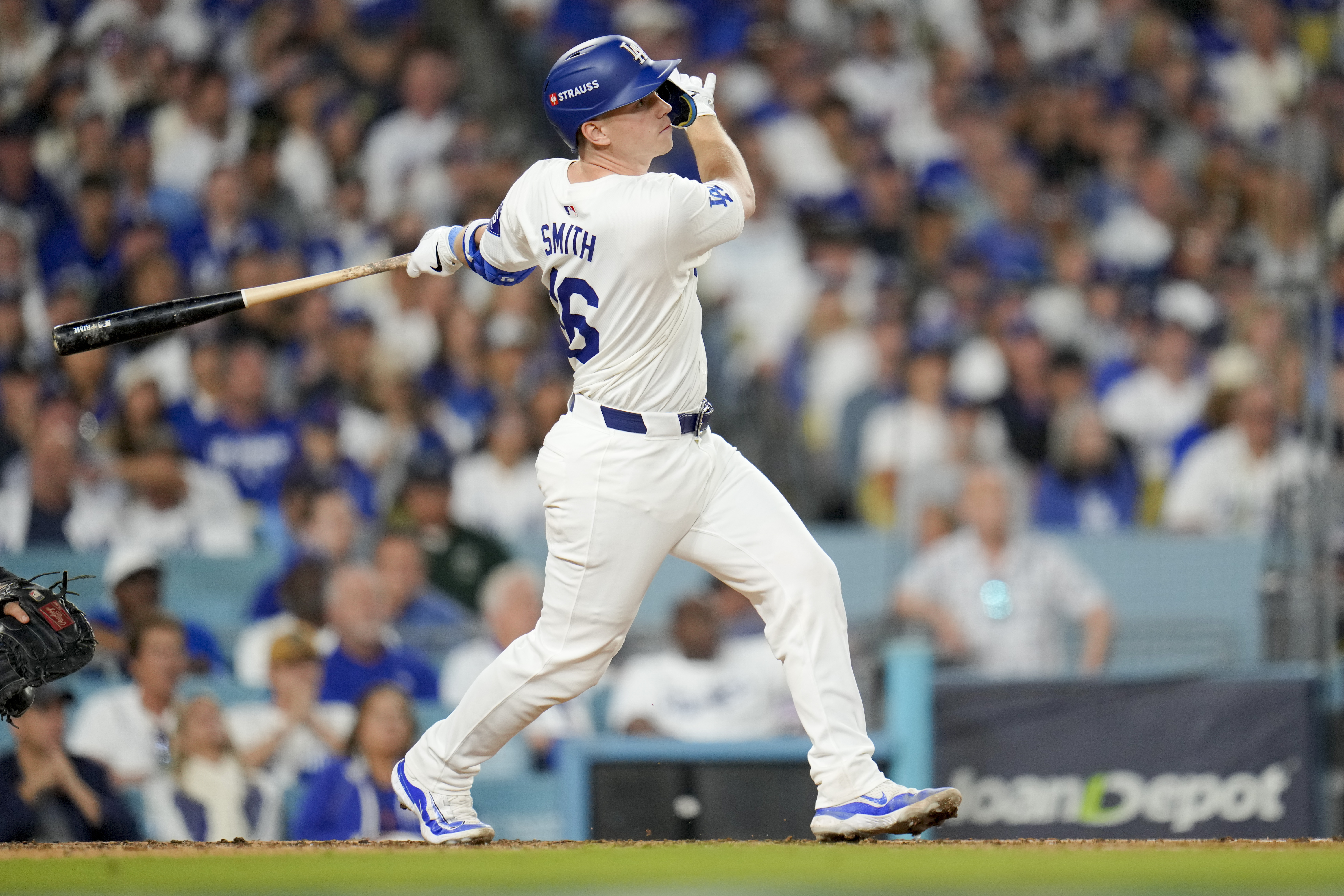 Los Angeles Dodgers' Will Smith watches his two-run home run against the New York Mets during the third inning in Game 6 of a baseball NL Championship Series, Sunday, Oct. 20, 2024, in Los Angeles. (AP Photo/Julio Cortez)