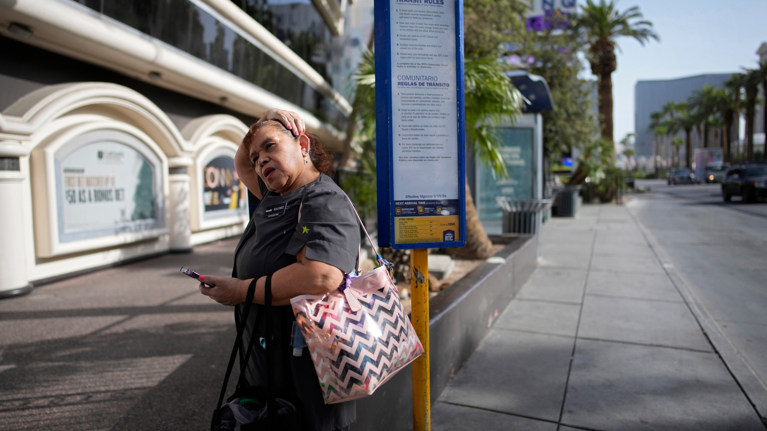 Haydee Zetino waits for the bus after working a shift as a maid at Harrah's hotel-casino along the Las Vegas Strip, Thursday, Sept. 12, 2024, in Las Vegas. Zetino, an immigrant from El Salvador, gained temporary protected status since arriving in the wake of a major earthquake in 2001. (AP Photo/John Locher)