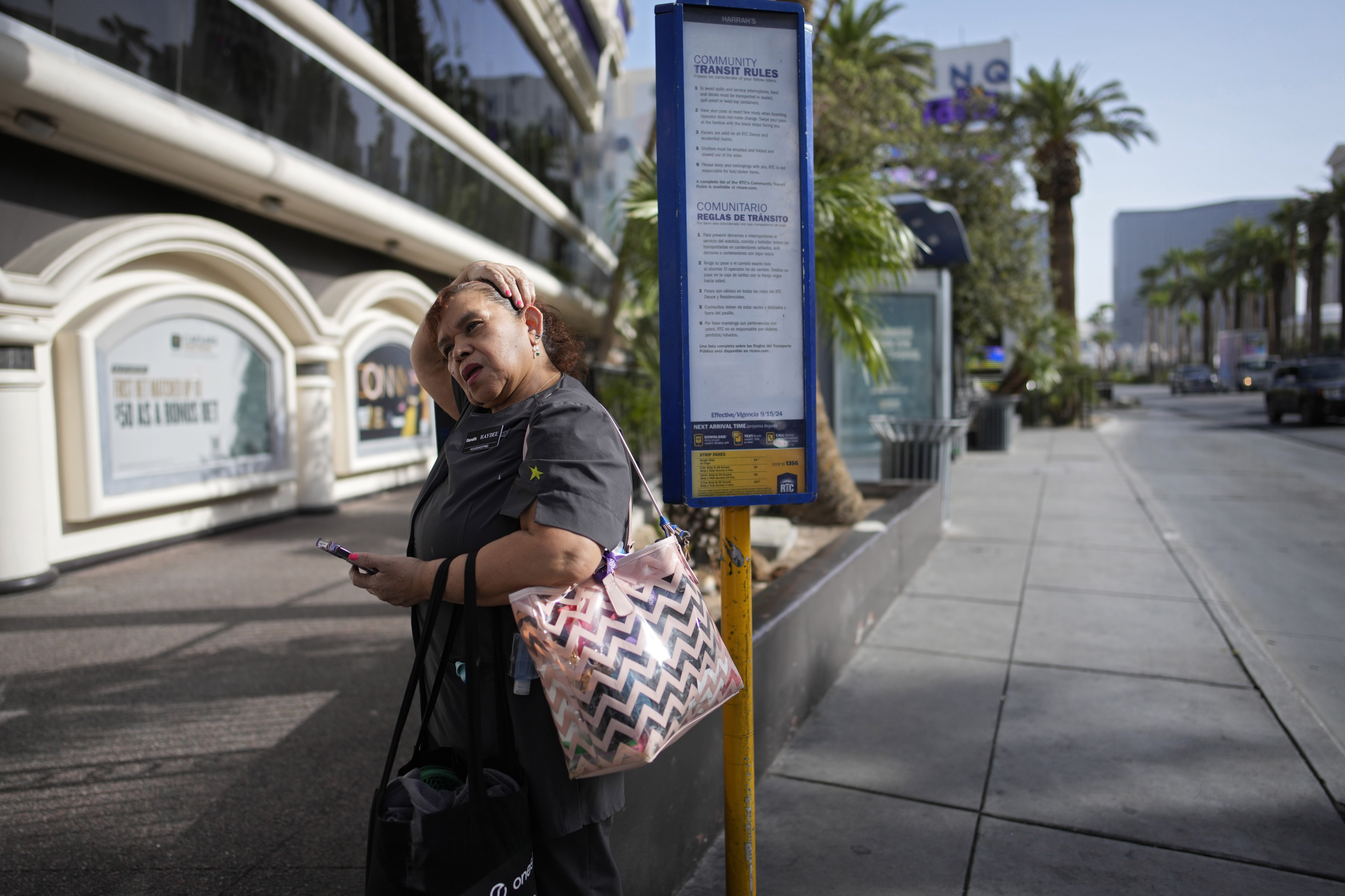 Haydee Zetino waits for the bus after working a shift as a maid at Harrah's hotel-casino along the Las Vegas Strip, Thursday, Sept. 12, 2024, in Las Vegas. Zetino, an immigrant from El Salvador, gained temporary protected status since arriving in the wake of a major earthquake in 2001. (AP Photo/John Locher)