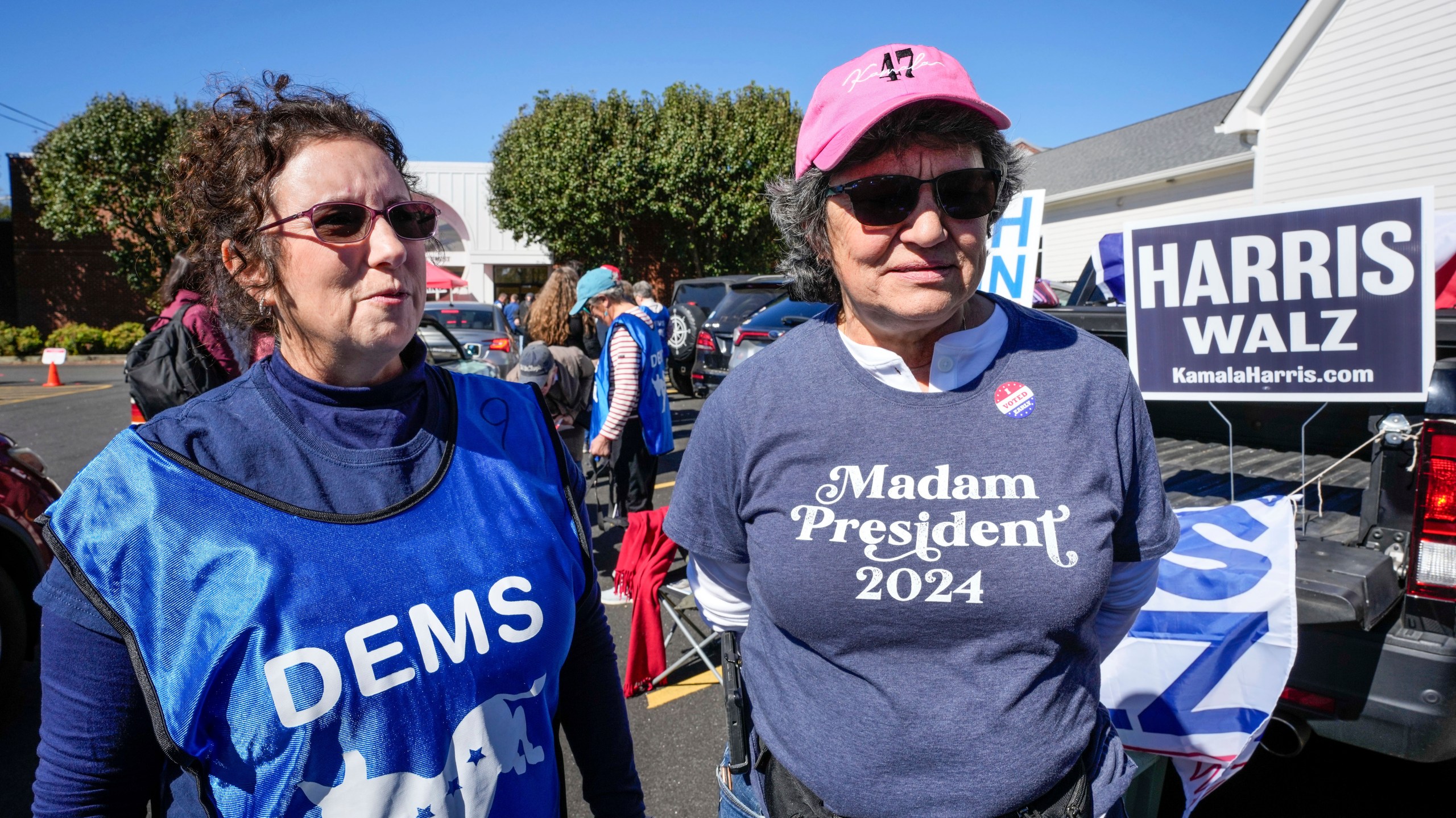 Supporters for Vice President Kamala Harris, Juliette Delgado, left, and Toni Mangan, both of Rutherford County, outside the Rutherford County Annex Building, where early voting was taking place, Thursday, Oct. 17, 2024 in Rutherfordton, N.C. (AP Photo/Kathy Kmonicek)