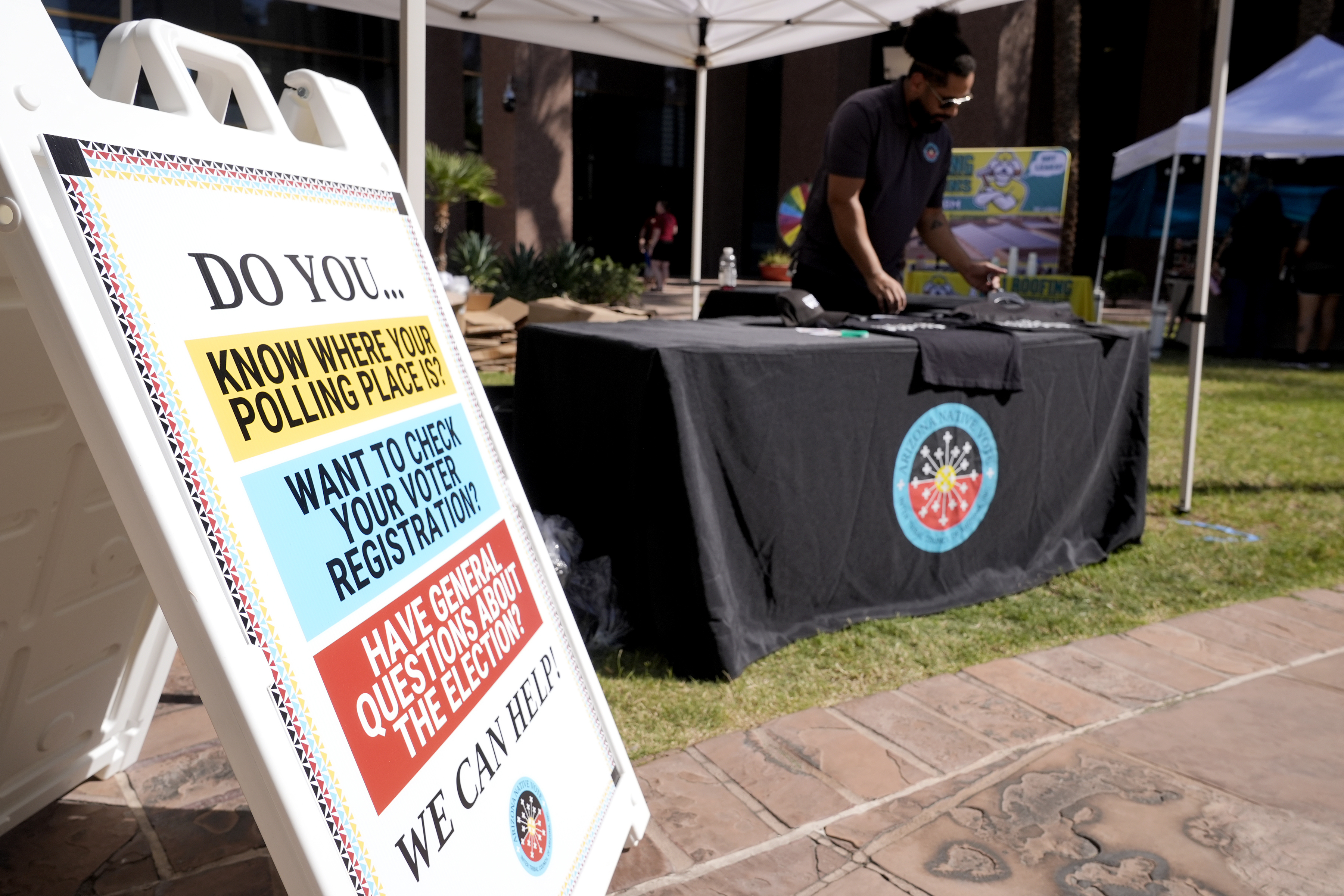 The Inter Tribal Council of Arizona, Inc., has a Arizona Native Vote booth at an Indigenous Peoples' Day event, Monday, Oct. 14, 2024, in Phoenix. (AP Photo/Ross D. Franklin)