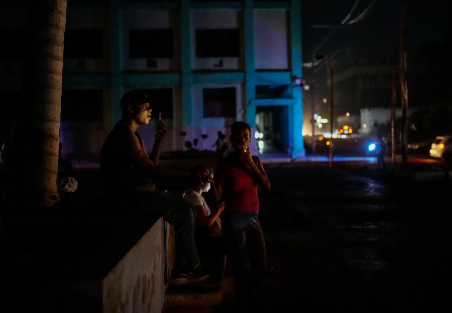 Residents pass the time during a blackout following the failure of a major power plant in Havana, Cuba, Sunday, Oct. 20, 2024. (AP Photo/Ramon Espinosa)