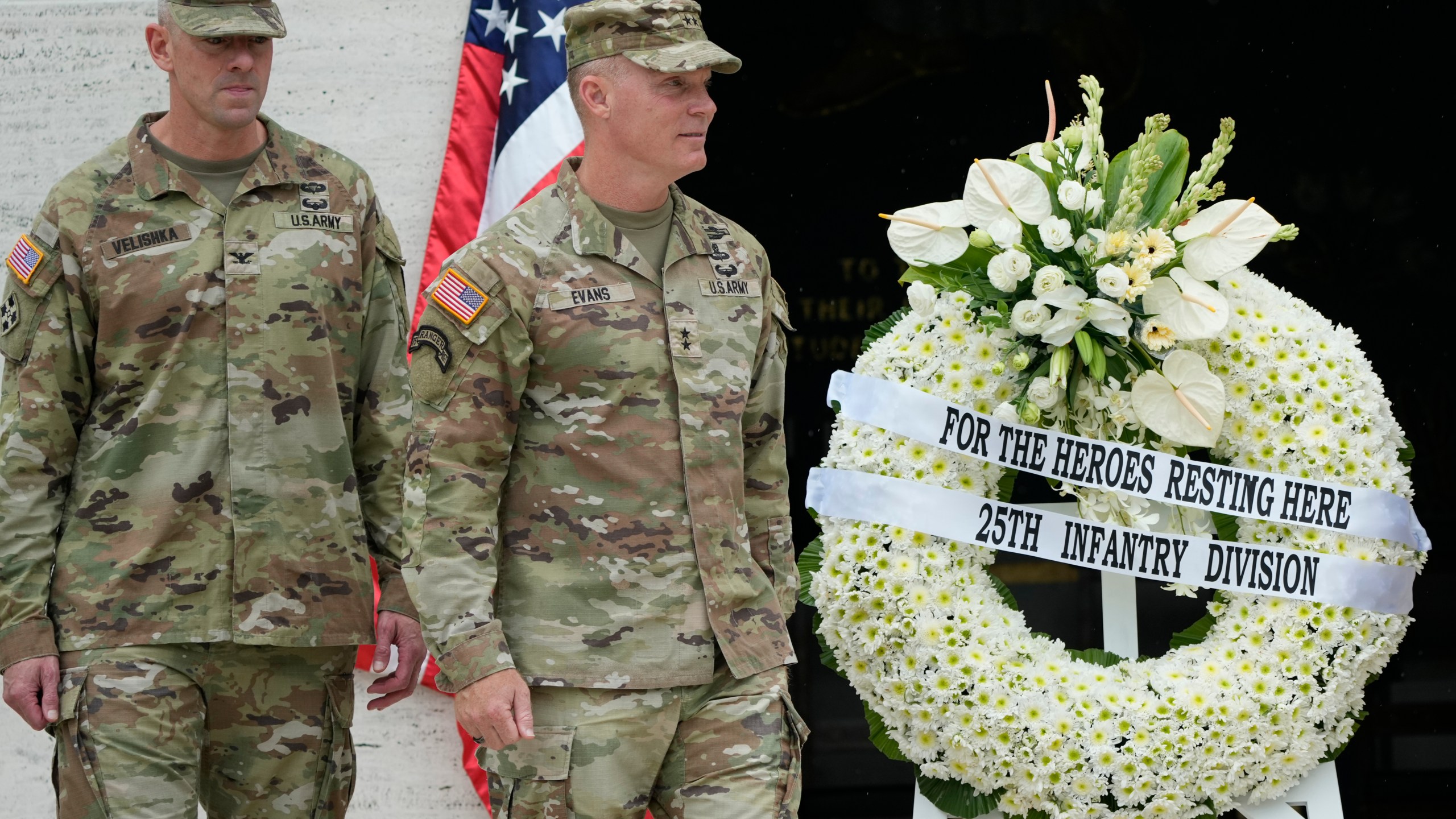 U.S. Maj. Gen. Marcus Evans, right, commanding general of the U.S. Army's 25th Infantry Division walks beside a wreath during rites to honor American soldiers died during World War II at the Manila American Cemetery and Memorial in Taguig, Philippines Monday, Oct. 21, 2024. (AP Photo/Aaron Favila)