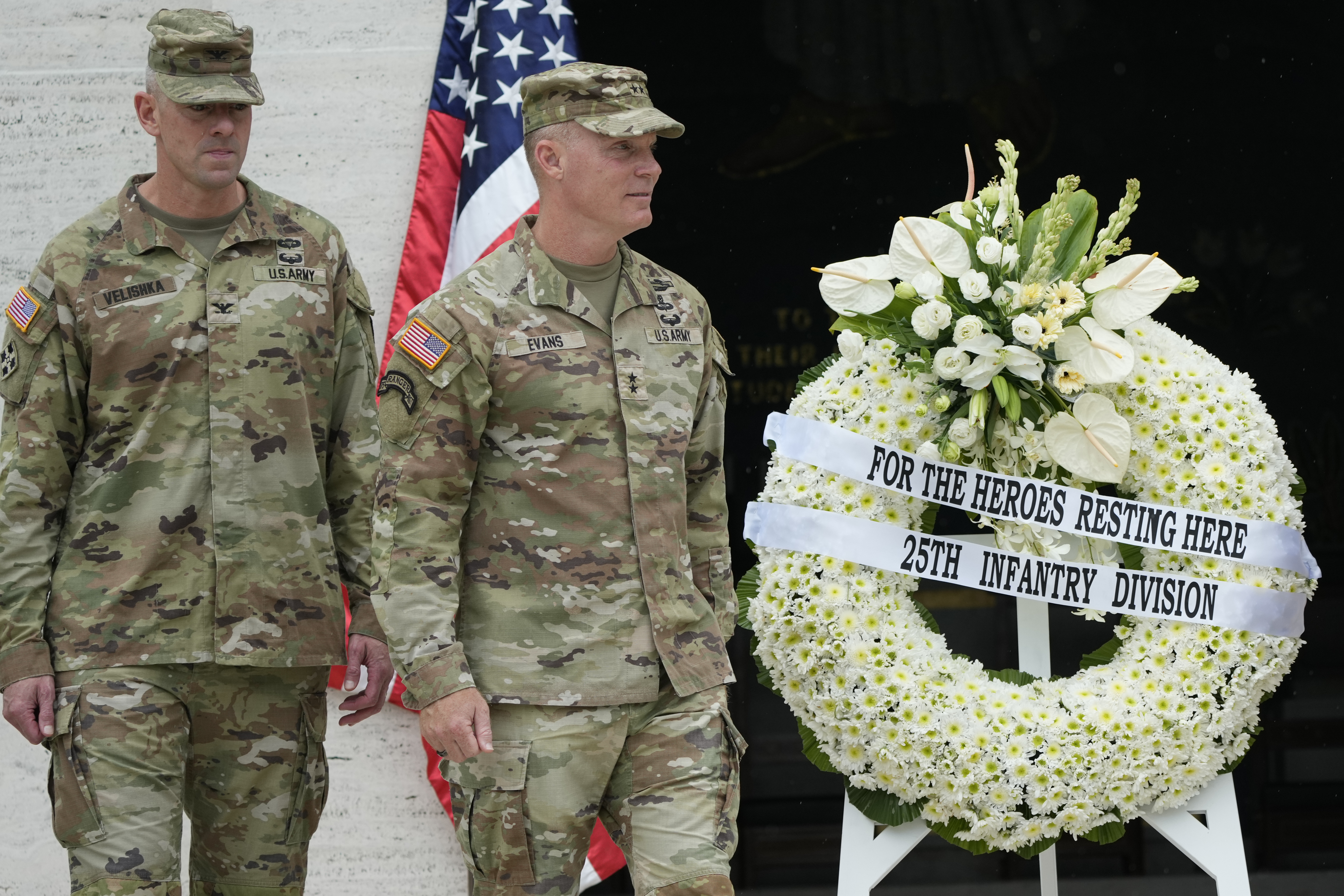 U.S. Maj. Gen. Marcus Evans, right, commanding general of the U.S. Army's 25th Infantry Division walks beside a wreath during rites to honor American soldiers died during World War II at the Manila American Cemetery and Memorial in Taguig, Philippines Monday, Oct. 21, 2024. (AP Photo/Aaron Favila)