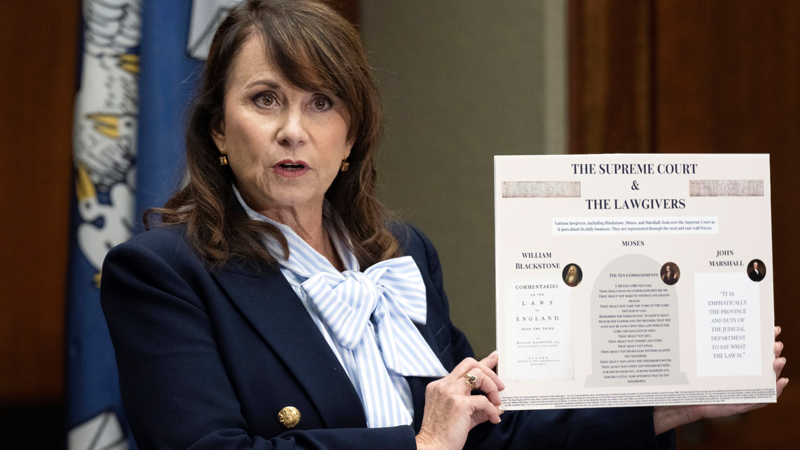 FILE - Louisiana Attorney General Liz Murrill speaks holds up a mini-display showing the Ten Commandments during a press conference regarding the Ten Commandments in schools, Aug. 5, 2024, in Baton Rouge, La. (Hilary Scheinuk/The Advocate via AP, File)