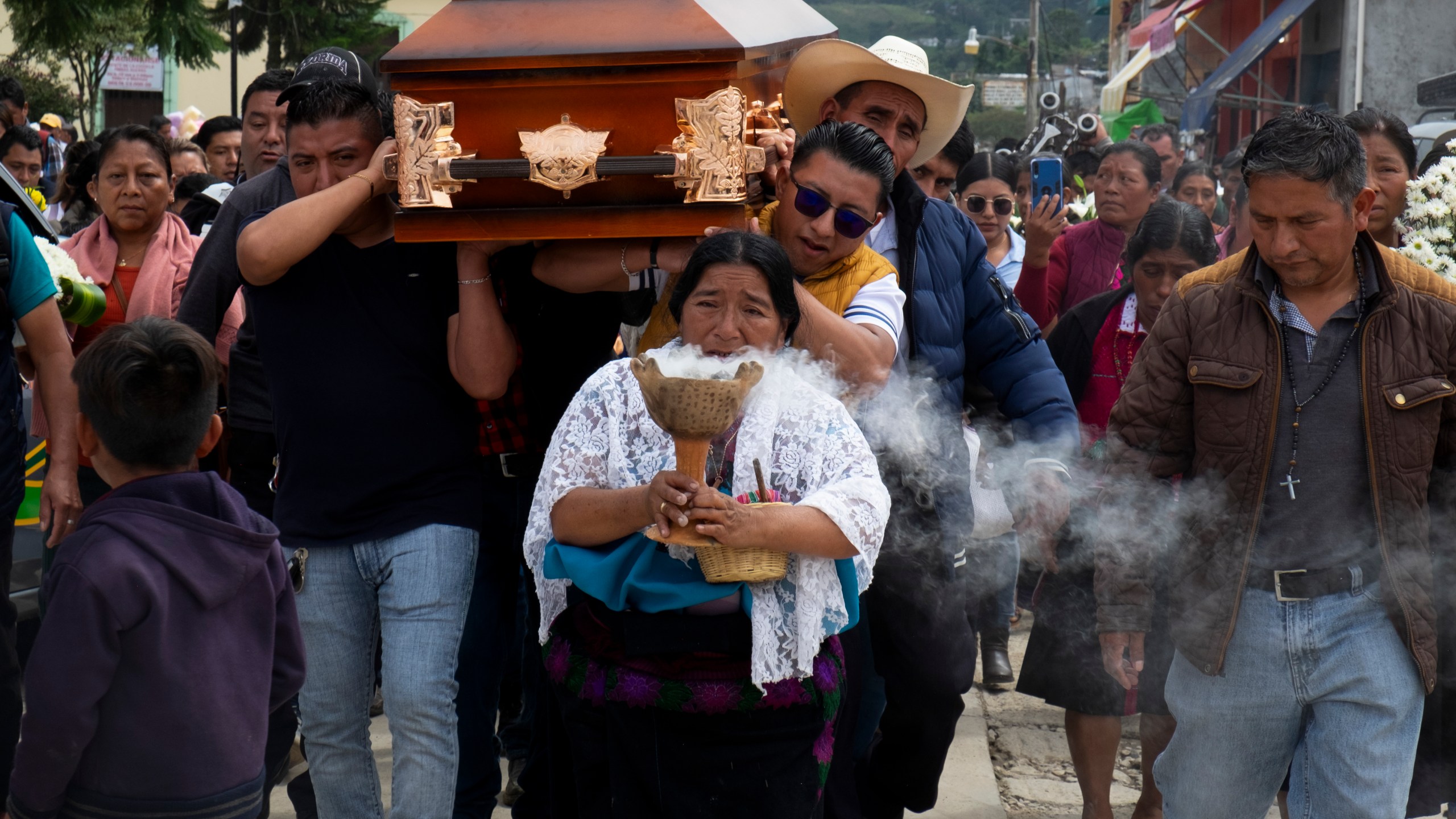 People carry the coffin of slain Catholic priest and activist Marcelo Pérez prior to a mass at the main plaza in San Andrés Larráinzar, Chiapas state, Mexico, Monday, Oct. 21, 2024. (AP Photo/Isabel Mateos)