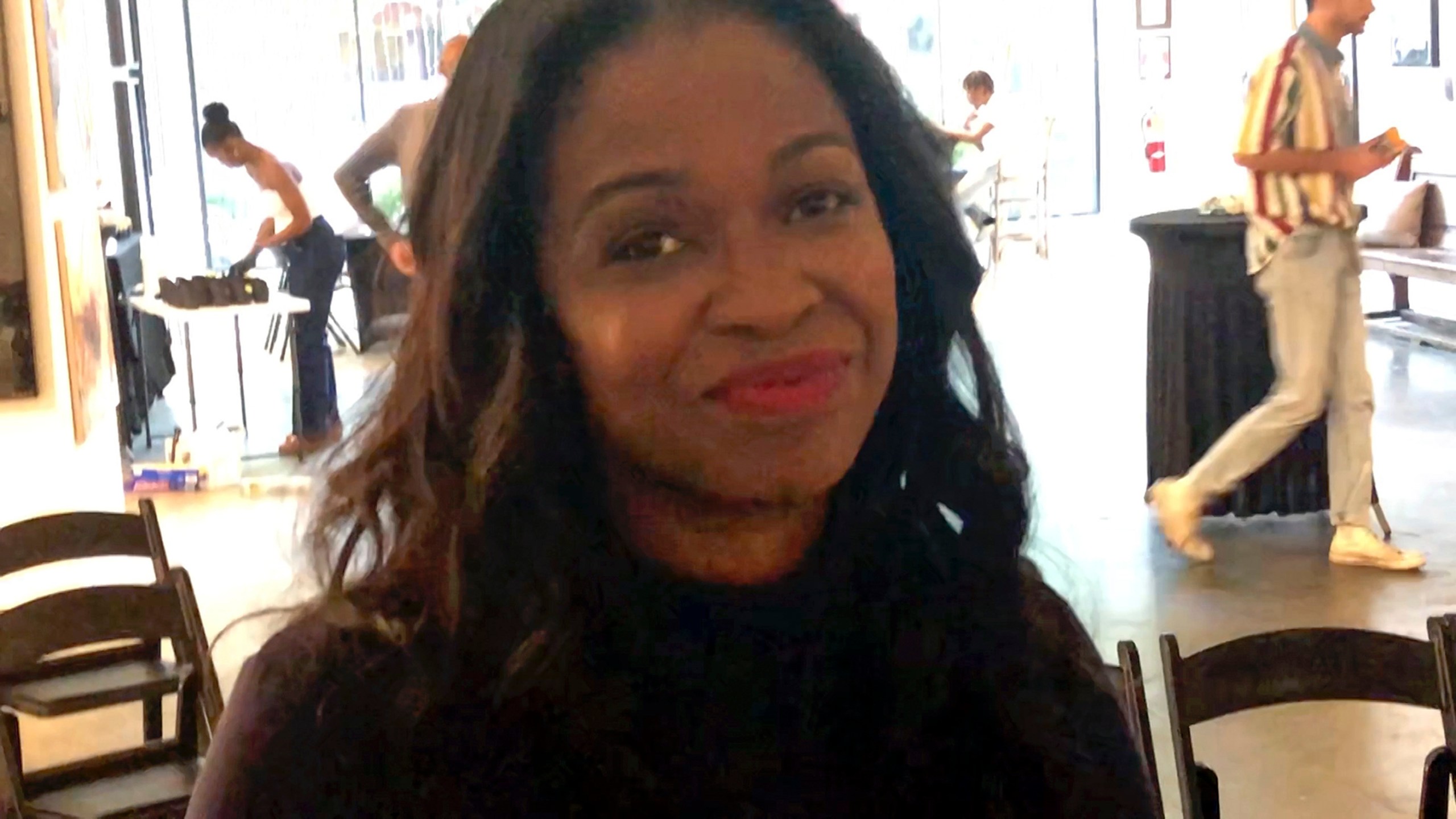 Karimah McFarlane, a Howard University graduate and owner of Buckhead Art & Company in Atlanta, poses for a photo on Sept. 10, 2024. She hosted a viewing party of the presidential debate between Republican presidential nominee former President Donald Trump and Democratic presidential nominee Vice President Kamala Harris, (AP Photo/Gary Fields)