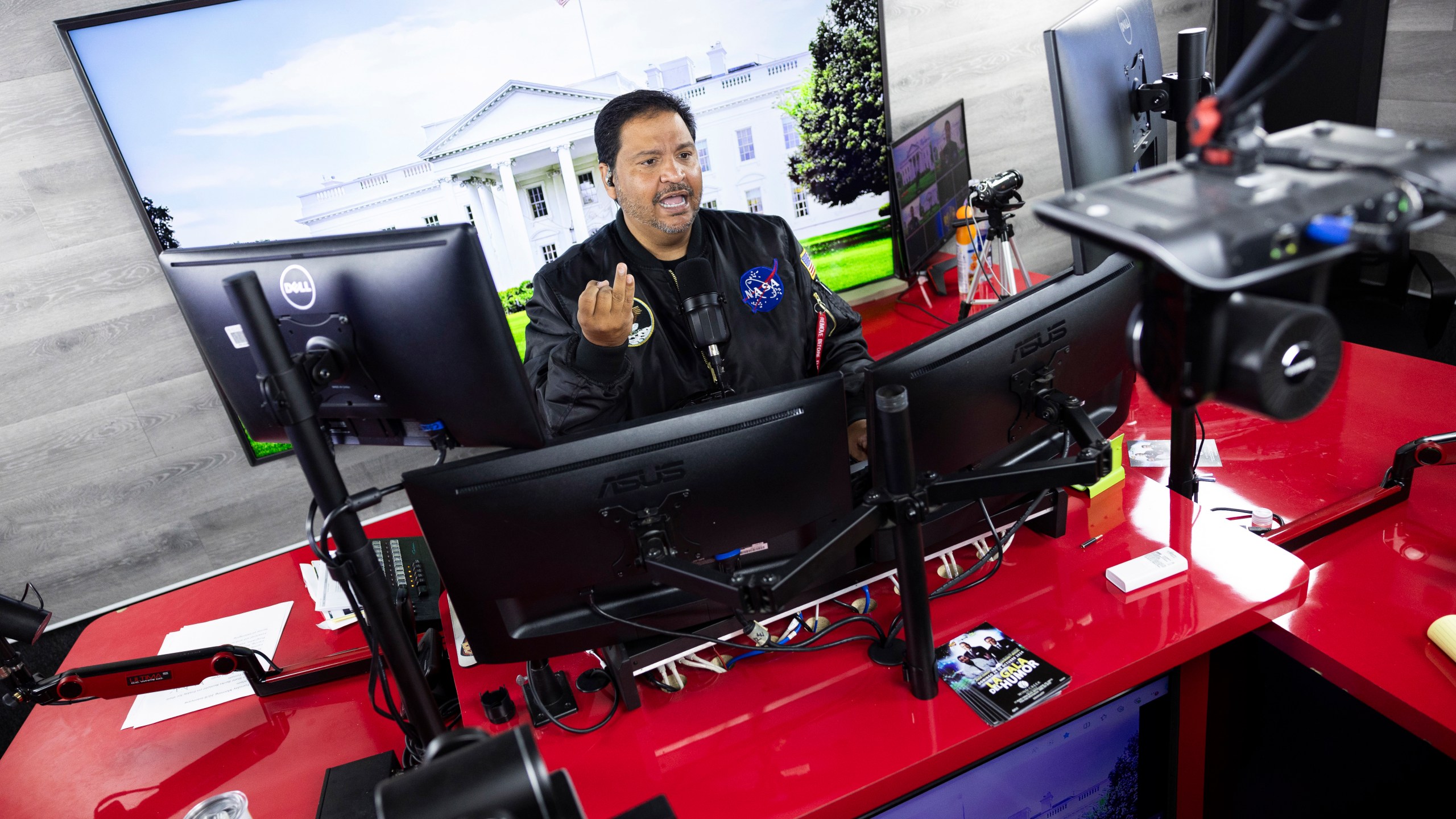 Radio host and owner of radio station La Mega 101.7 FM Victor Martinez on the air in Allentown, Pa., Tuesday, Oct. 15, 2024. (AP Photo/Ryan Collerd)