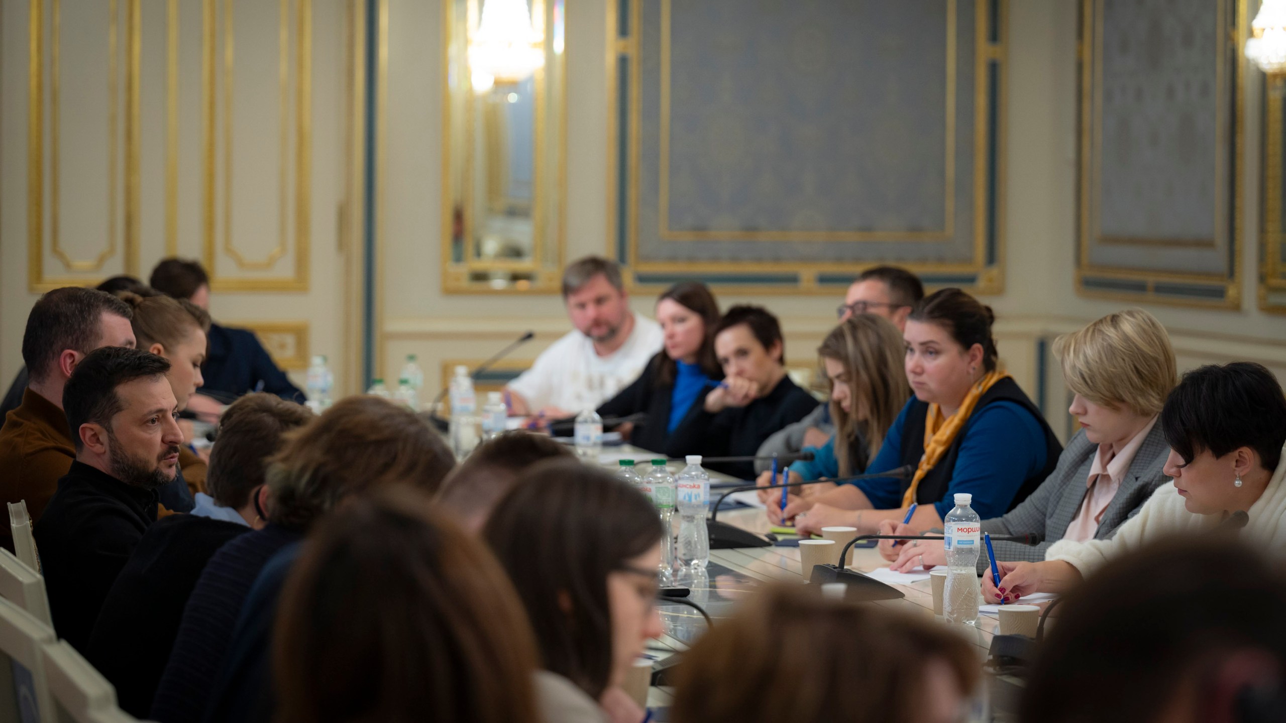 In this photo provided by the Ukrainian Presidential Press Office, Ukrainian President Volodymyr Zelenskyy, left, talks with Ukrainian journalists in Kyiv, Ukraine, Monday, Oct. 21, 2024. (Ukrainian Presidential Press Office via AP)