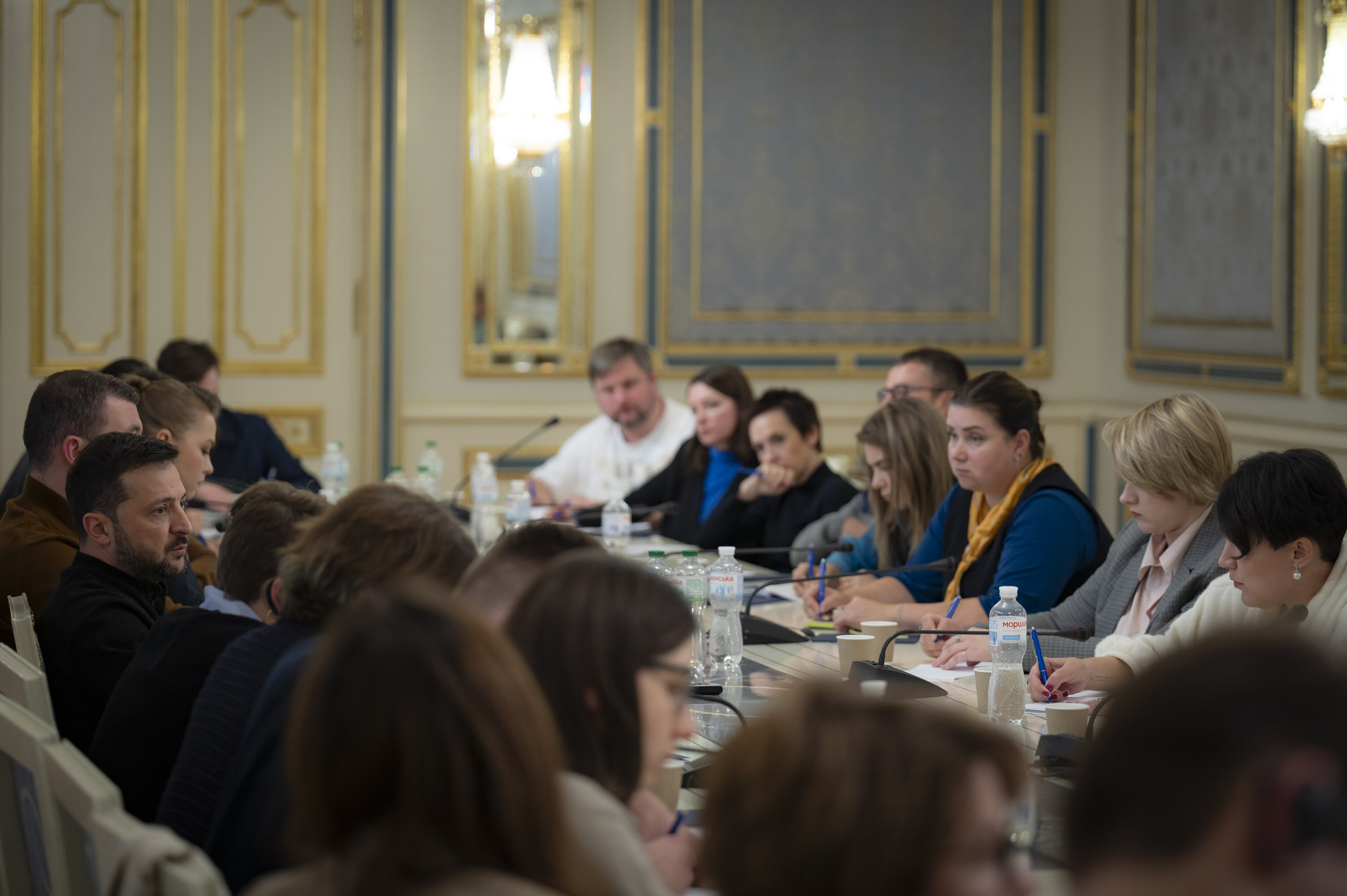 In this photo provided by the Ukrainian Presidential Press Office, Ukrainian President Volodymyr Zelenskyy, left, talks with Ukrainian journalists in Kyiv, Ukraine, Monday, Oct. 21, 2024. (Ukrainian Presidential Press Office via AP)