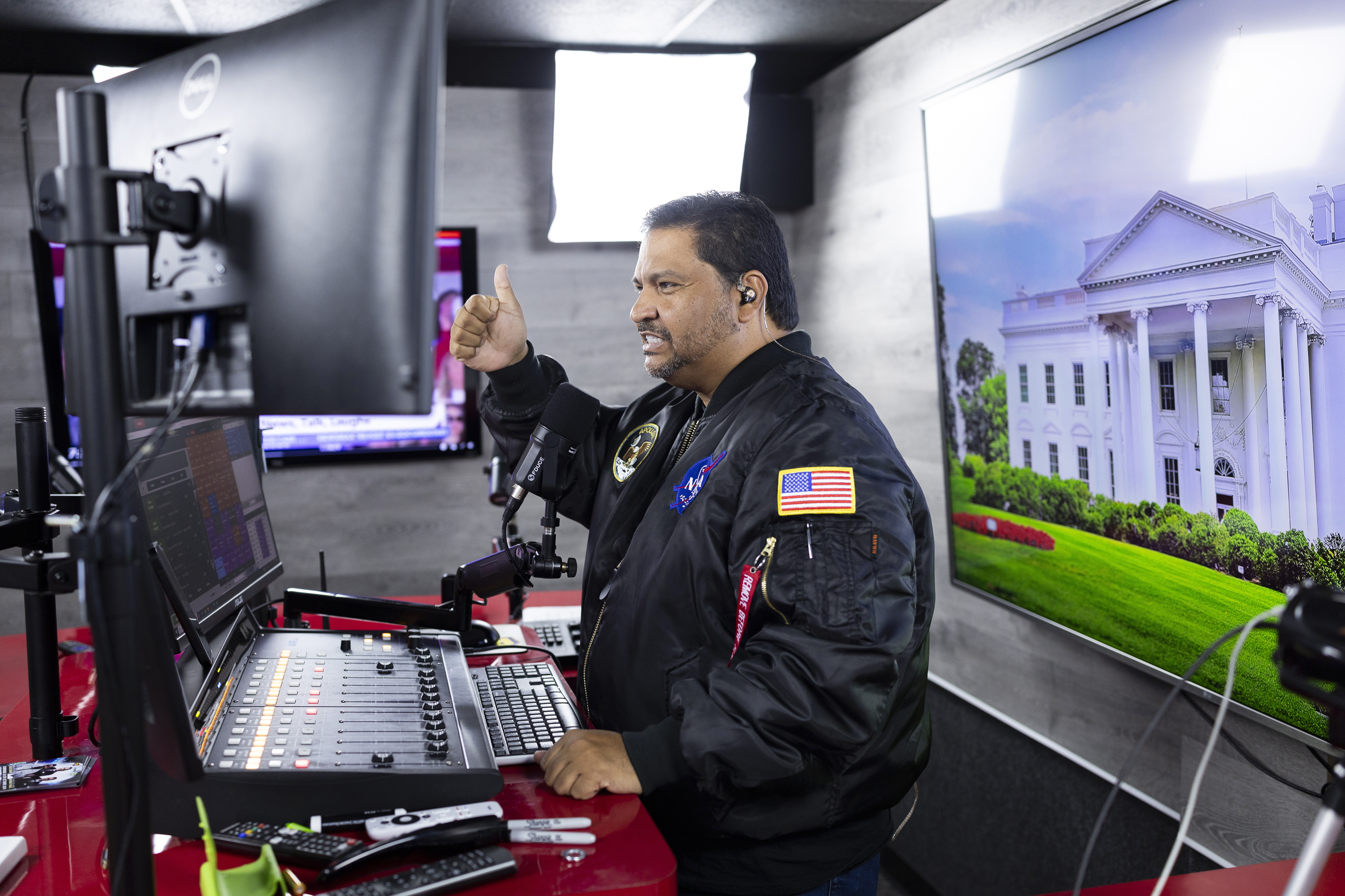 Radio host and owner of radio station La Mega 101.7 FM Victor Martinez on the air in Allentown, Pa., Tuesday, Oct. 15, 2024. (AP Photo/Ryan Collerd)