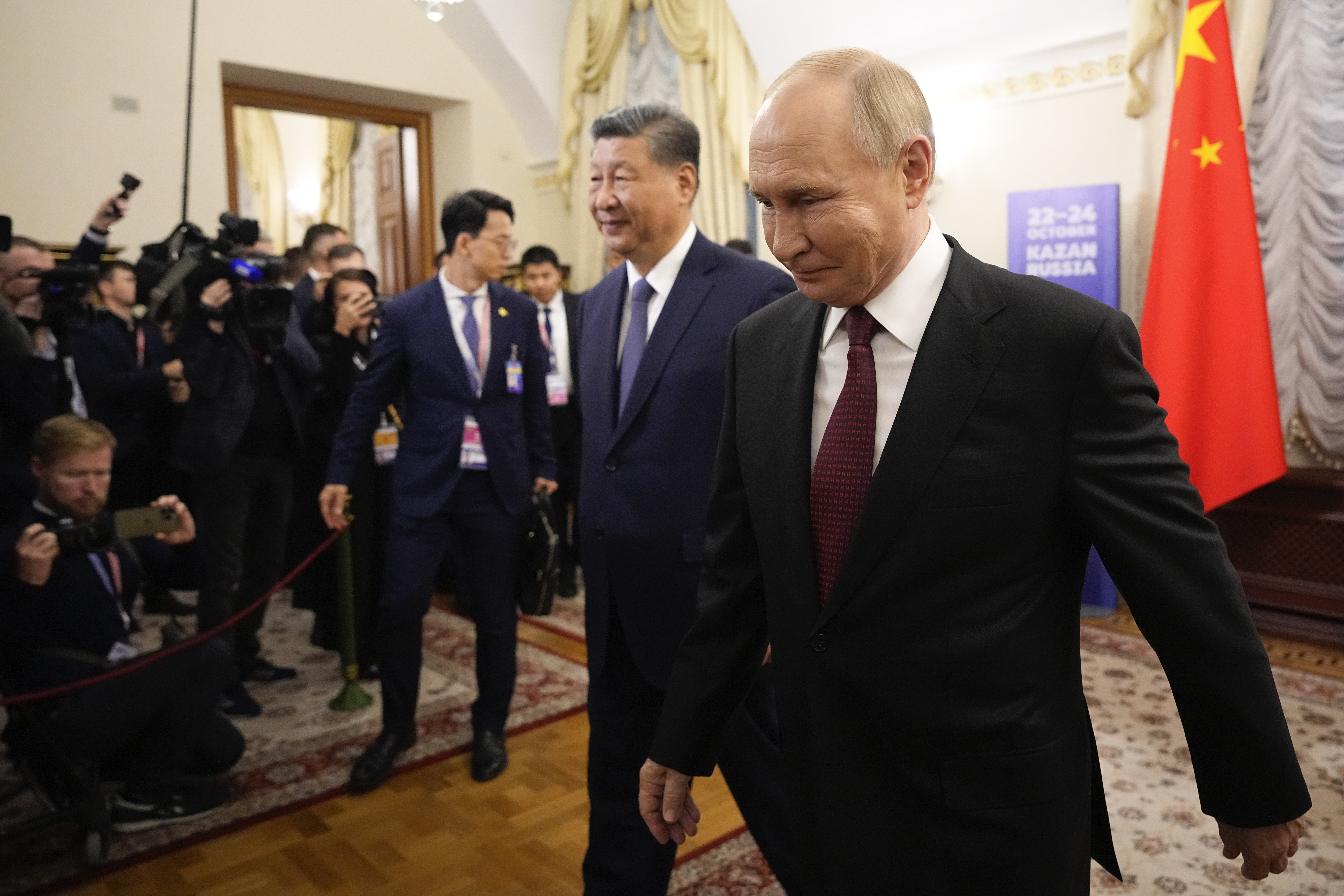 Russian President Vladimir Putin, right, and Chinese President Xi Jinping walk next to journalists during their meeting on the sidelines of BRICS Summit at Kazan Kremlin in Kazan, Russia, Tuesday, Oct. 22, 2024. (AP Photo/Alexander Zemlianichenko, Pool)