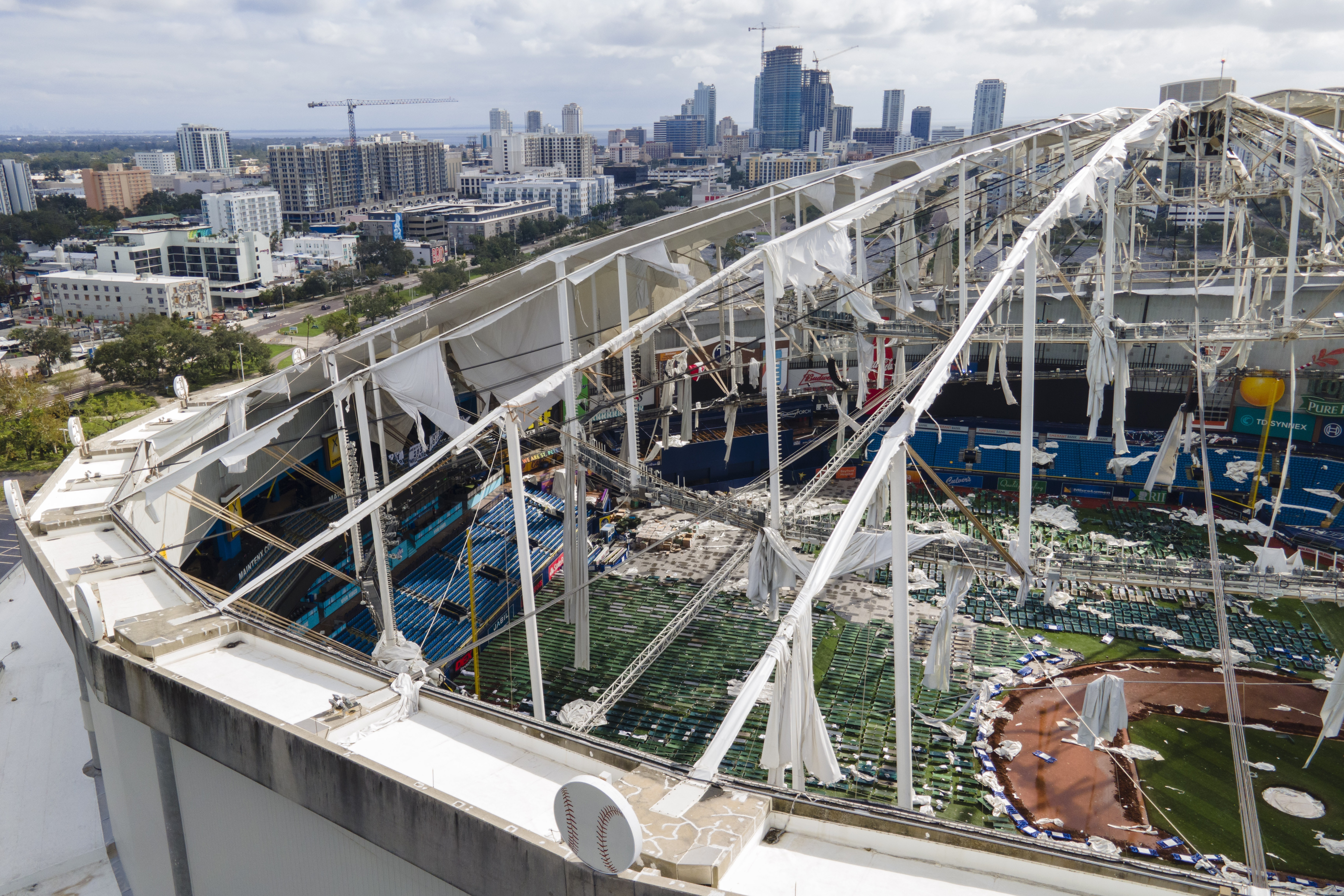 The roof of the Tropicana Field is damaged the morning after Hurricane Milton hit the region, Thursday, Oct. 10, 2024, in St. Petersburg, Fla. (AP Photo/Julio Cortez)