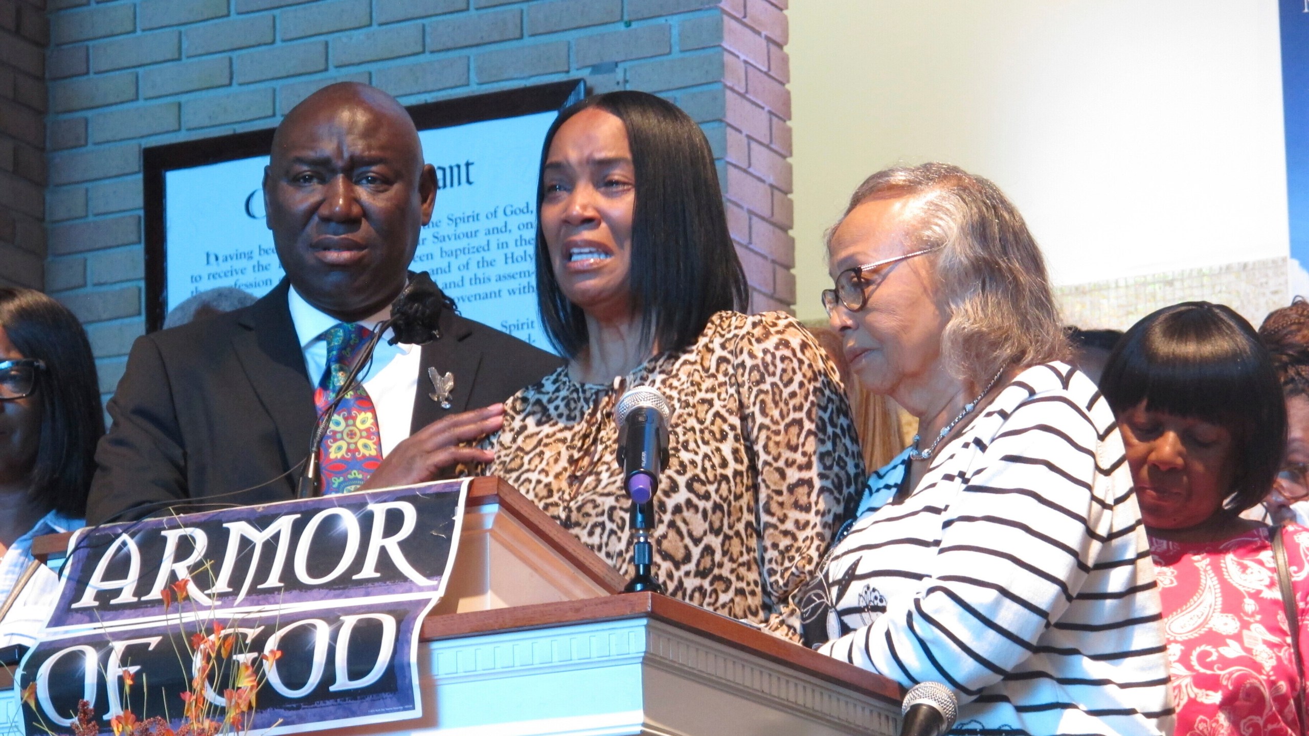 Regina Brinson, center, weeps at a news conference Tuesday, Oct. 22, 2024, while speaking alongside her mother, Katrena Alexander and attorney Ben Crump during a news conference in Jacksonville, Fla. Crump represents families of three of the seven people killed when a ferry dock walkway collapsed on Sapelo Island, Ga., on Saturday, Oct. 19. (AP Photo/Russ Bynum)