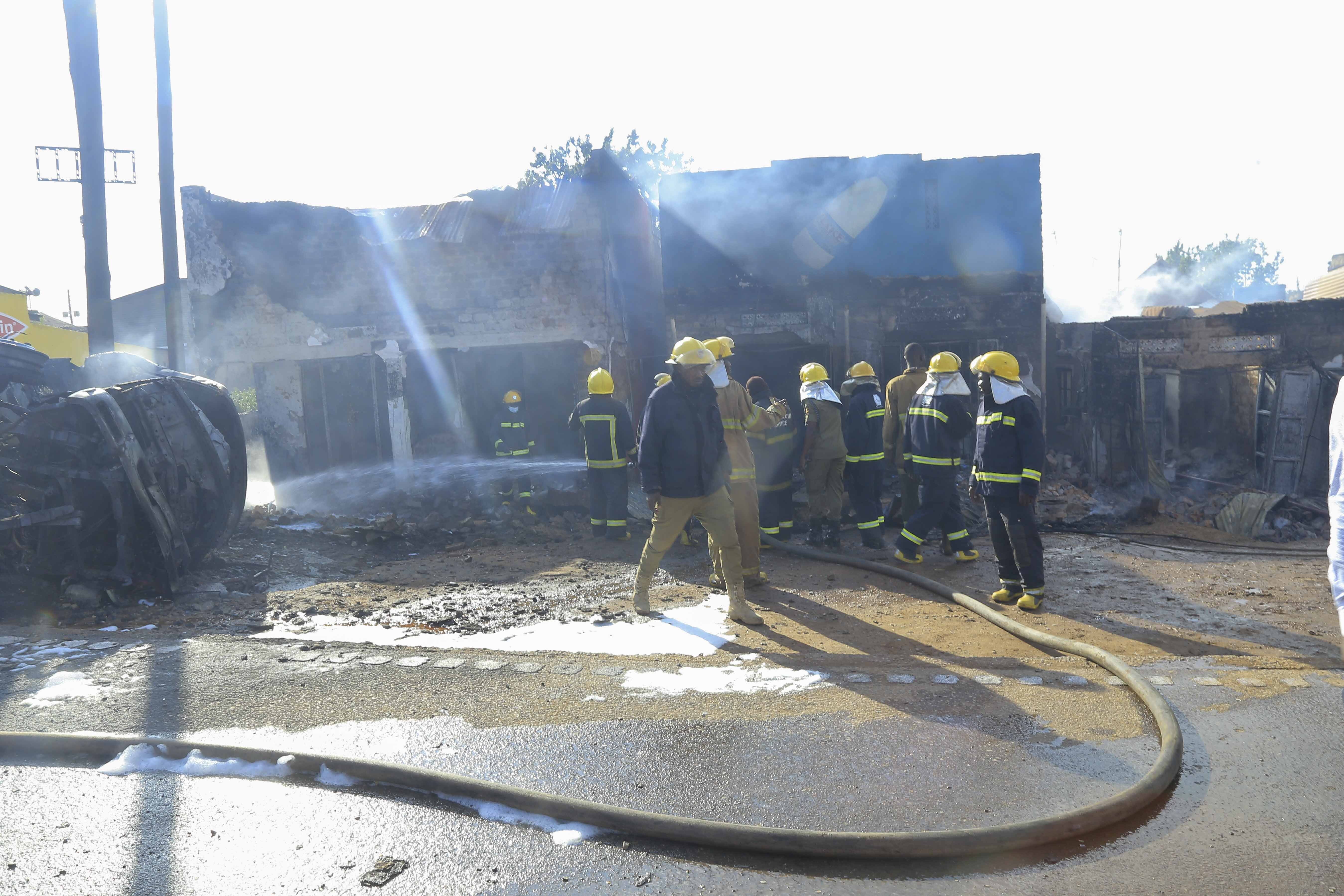 Firefighters try to contain a fire after a fuel truck exploded next to a highway on the outskirts of Kampala, Uganda, Tuesday, Oct. 22, 2024. (AP Photo)