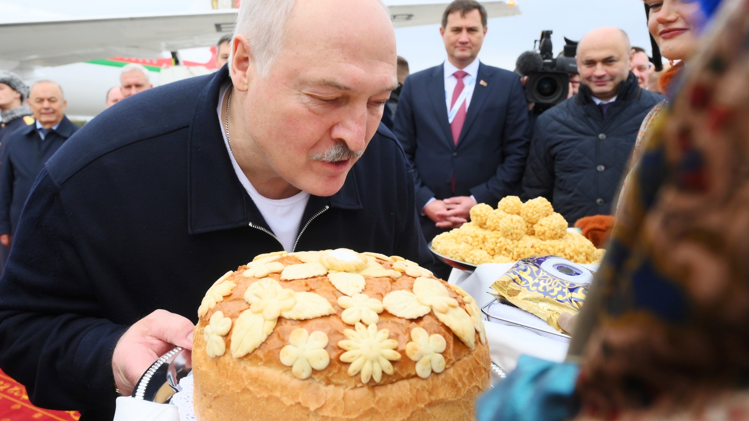 Belarusian President Alexander Lukashenko kisses a traditional Russian bread upon his arrival at Kazan International Airport for the BRICS summit in Kazan, Russia, Wednesday, Oct. 23, 2024. (Ekaterina Chesnokova/Photo host brics-russia2024.ru via AP)