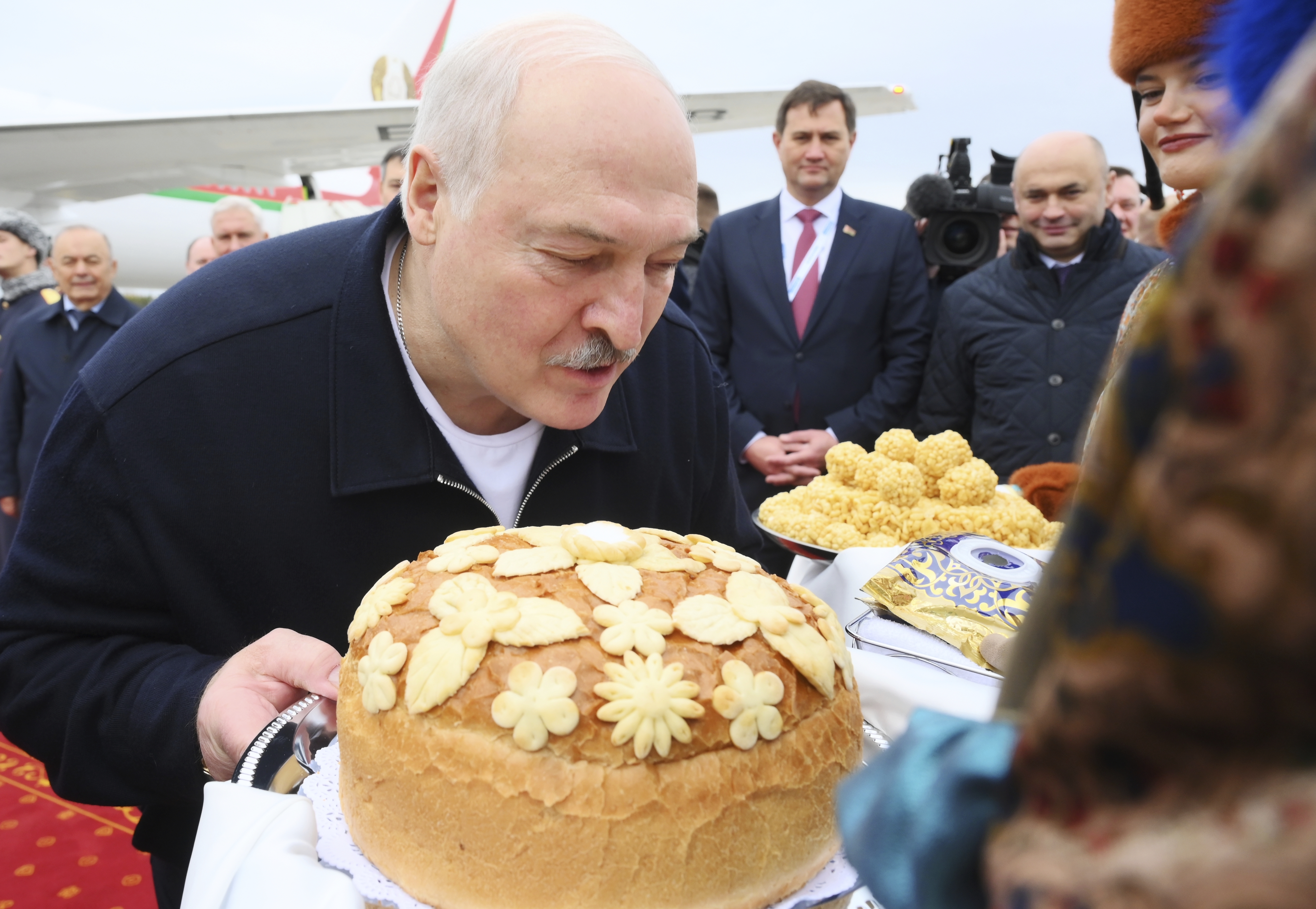 Belarusian President Alexander Lukashenko kisses a traditional Russian bread upon his arrival at Kazan International Airport for the BRICS summit in Kazan, Russia, Wednesday, Oct. 23, 2024. (Ekaterina Chesnokova/Photo host brics-russia2024.ru via AP)