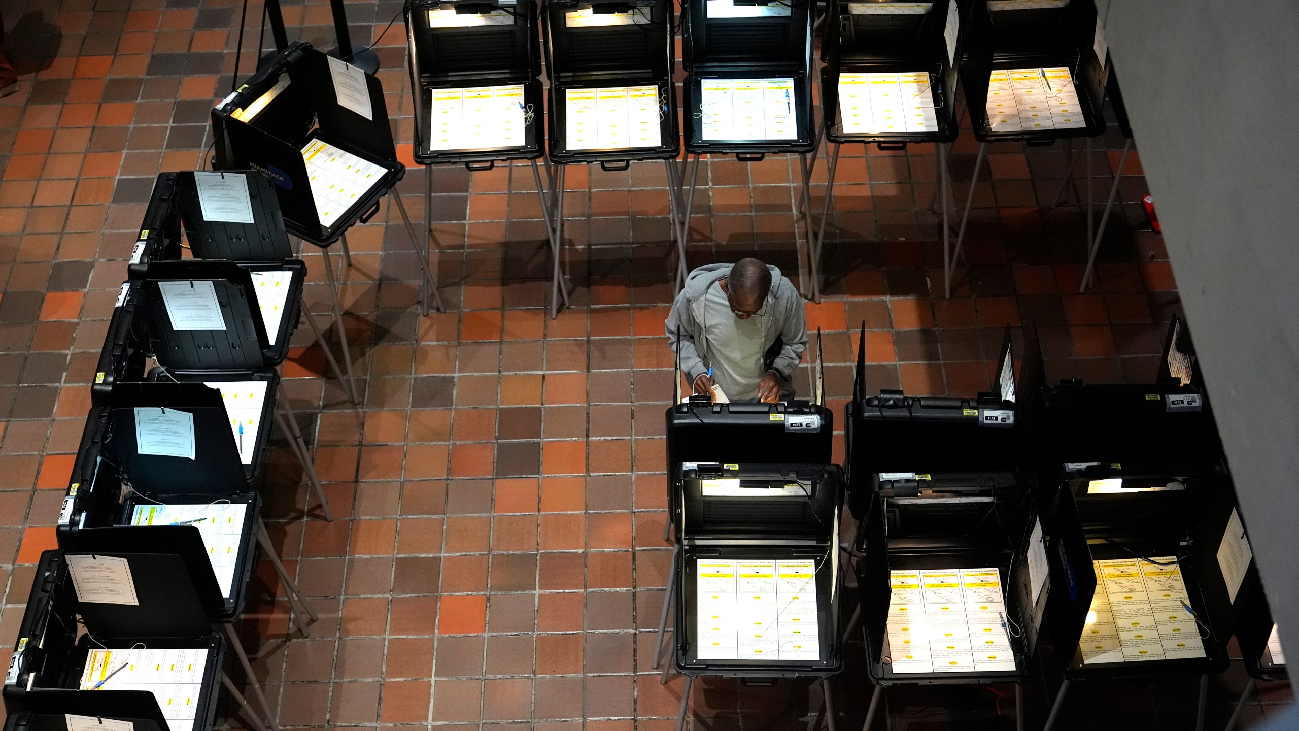 FILE - A person votes on the first day of early voting in the general election, Oct. 21, 2024, in Miami. (AP Photo/Lynne Sladky, File)