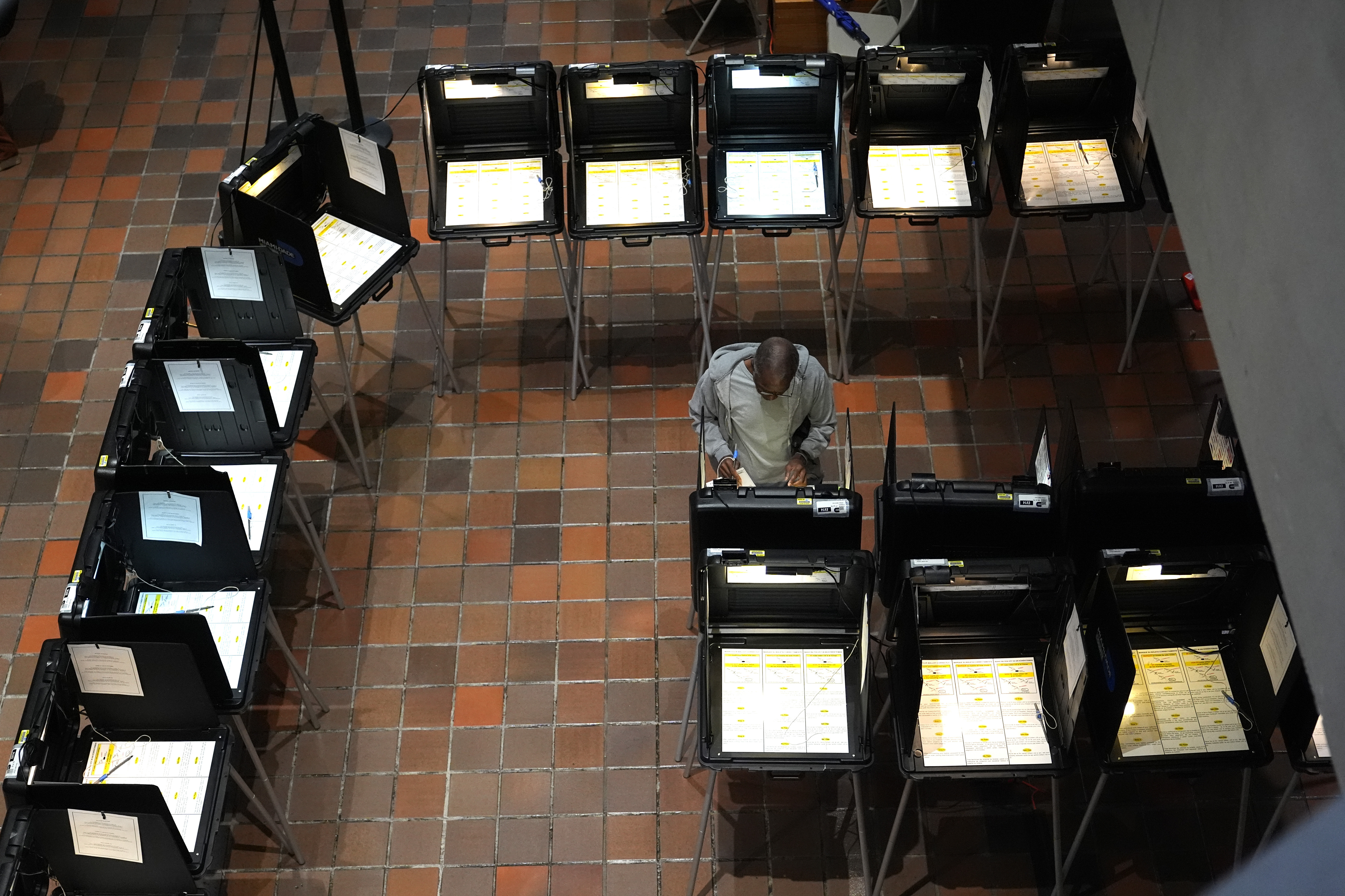 FILE - A person votes on the first day of early voting in the general election, Oct. 21, 2024, in Miami. (AP Photo/Lynne Sladky, File)