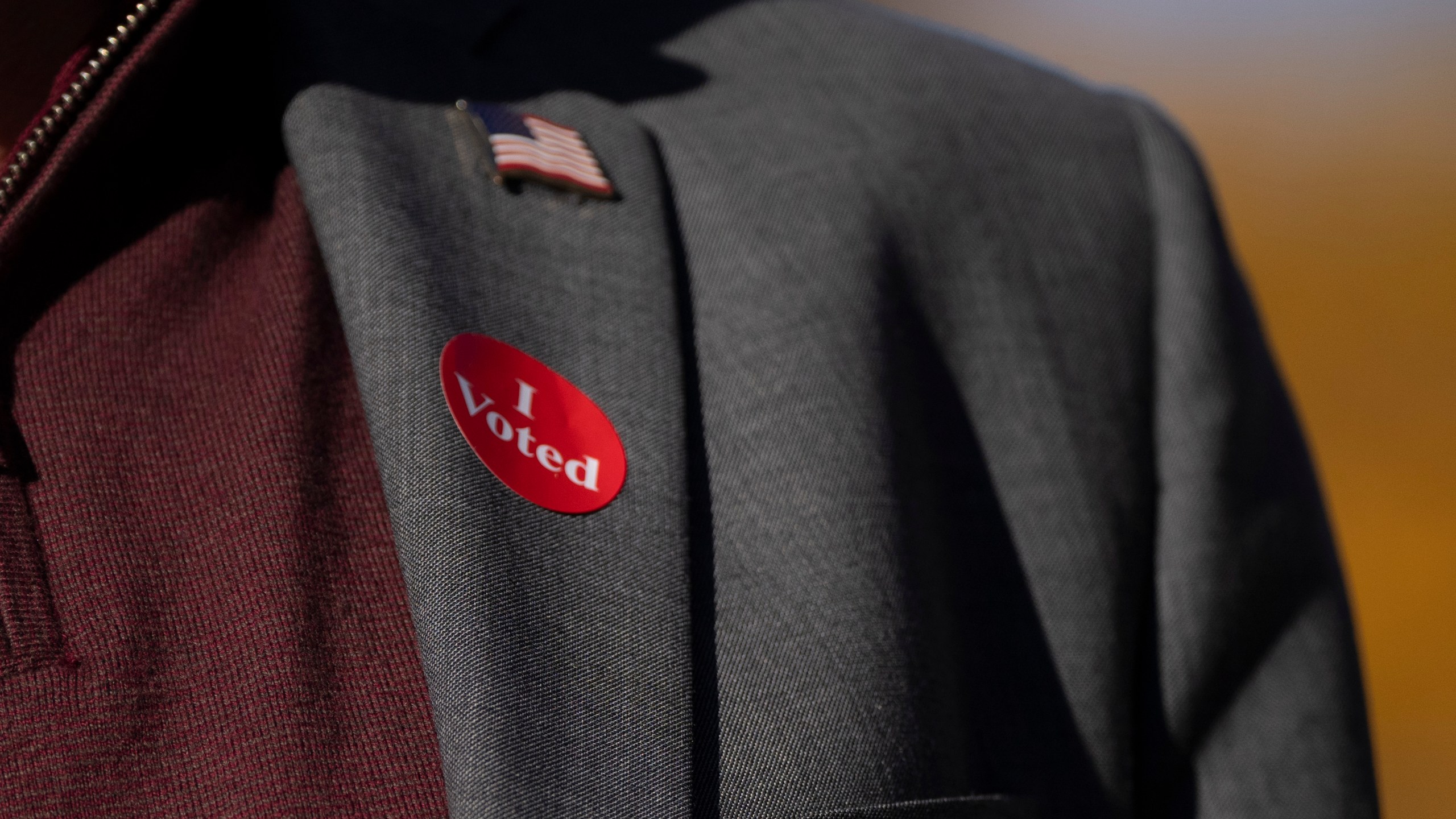 Democratic vice presidential nominee Minnesota Gov. Tim Walz wears an "I voted" sticker as he speaks to the press after early voting at the Ramsey County Elections office in St. Paul, Minn., Wednesday, Oct. 23, 2024. (Renée Jones Schneider/Star Tribune via AP, Pool)