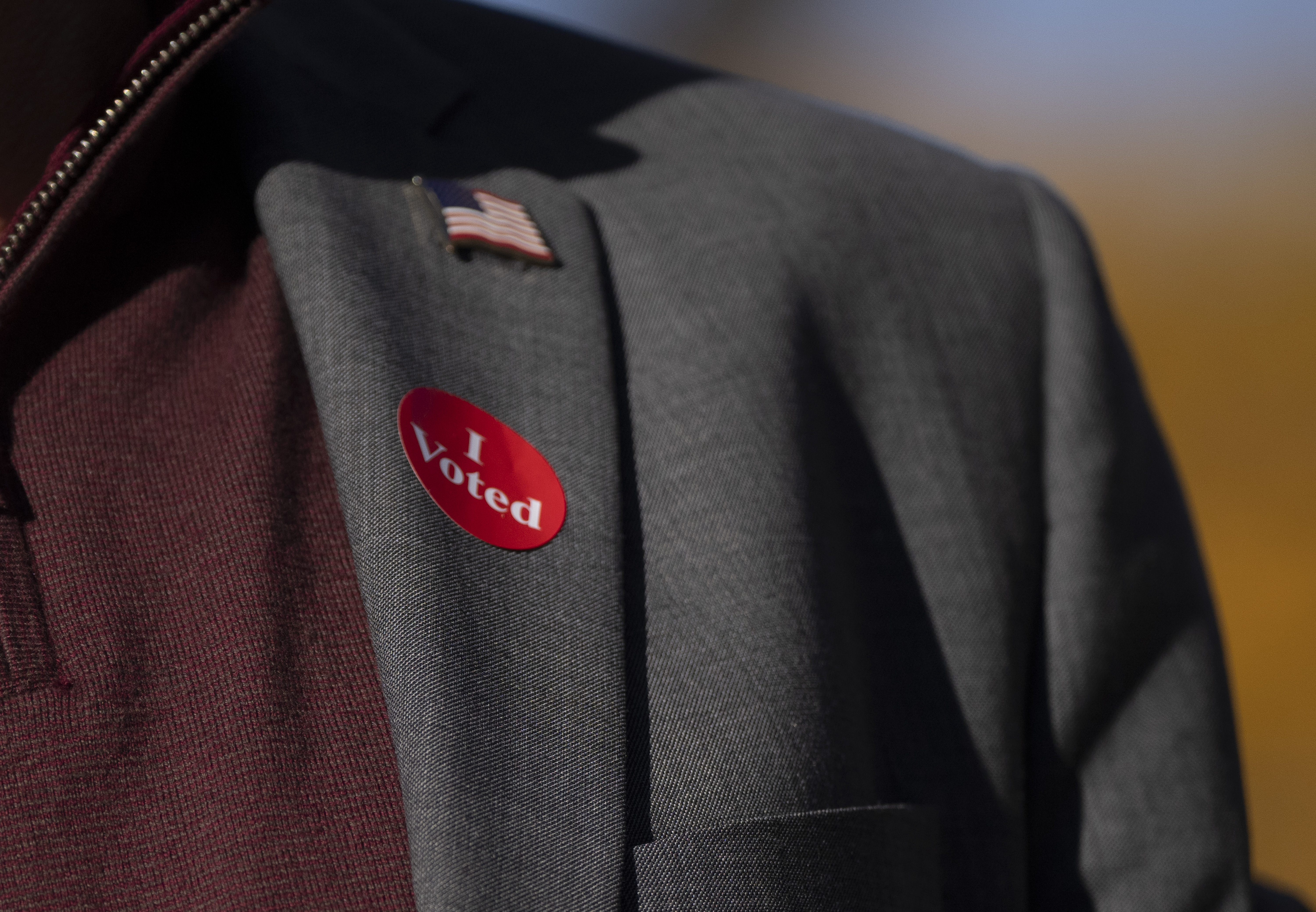 Democratic vice presidential nominee Minnesota Gov. Tim Walz wears an "I voted" sticker as he speaks to the press after early voting at the Ramsey County Elections office in St. Paul, Minn., Wednesday, Oct. 23, 2024. (Renée Jones Schneider/Star Tribune via AP, Pool)