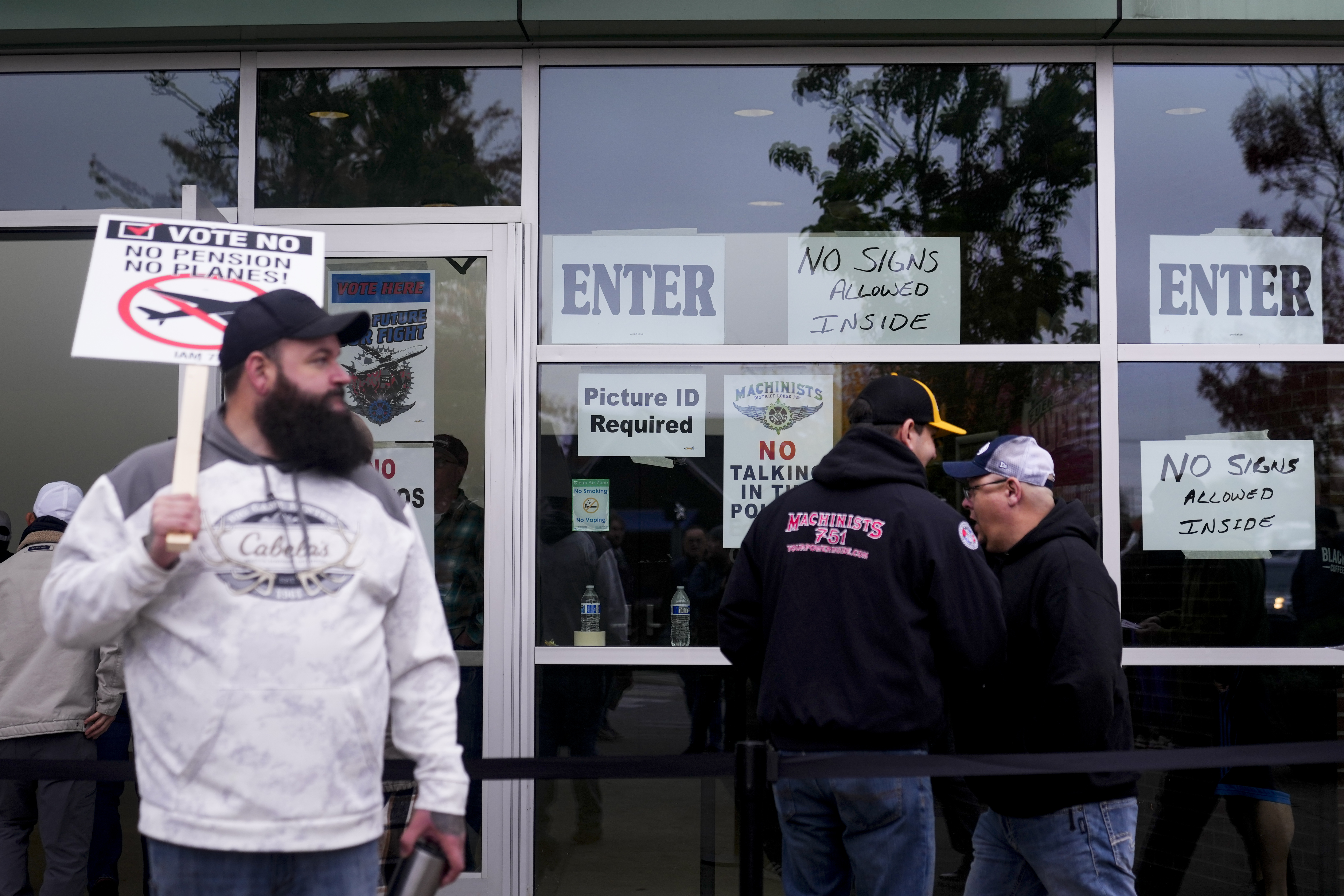 Boeing employees on strike enter a voting location to cast their ballots on a new contract offer from the company, Wednesday, Oct. 23, 2024, at the Angel of the Winds Arena in Everett, Wash. (AP Photo/Lindsey Wasson)