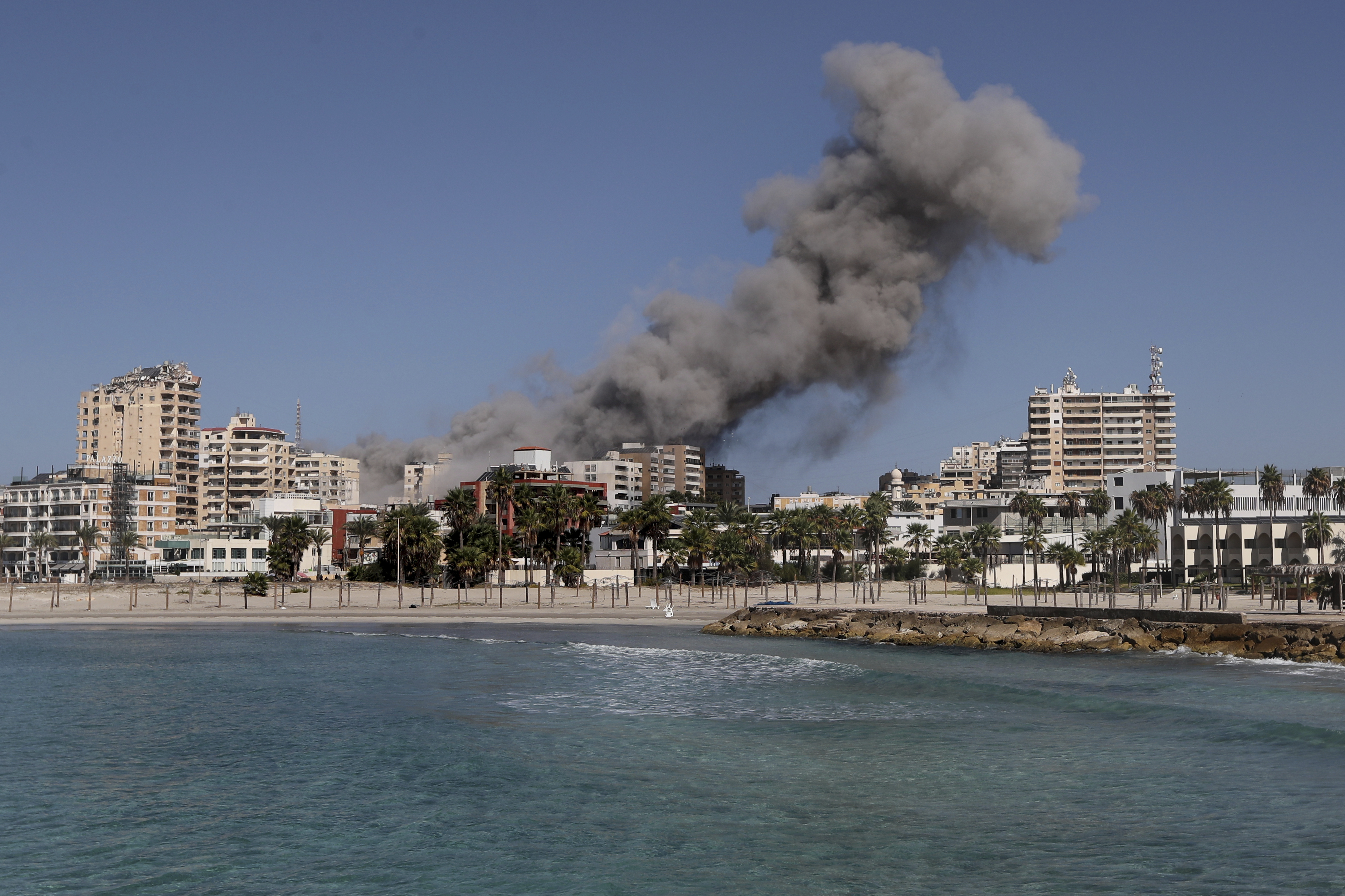 Smoke rises from buildings hit in an Israeli airstrike in Tyre, Lebanon, Wednesday, Oct. 23, 2024. (AP Photo/Mohammad Zaatari)