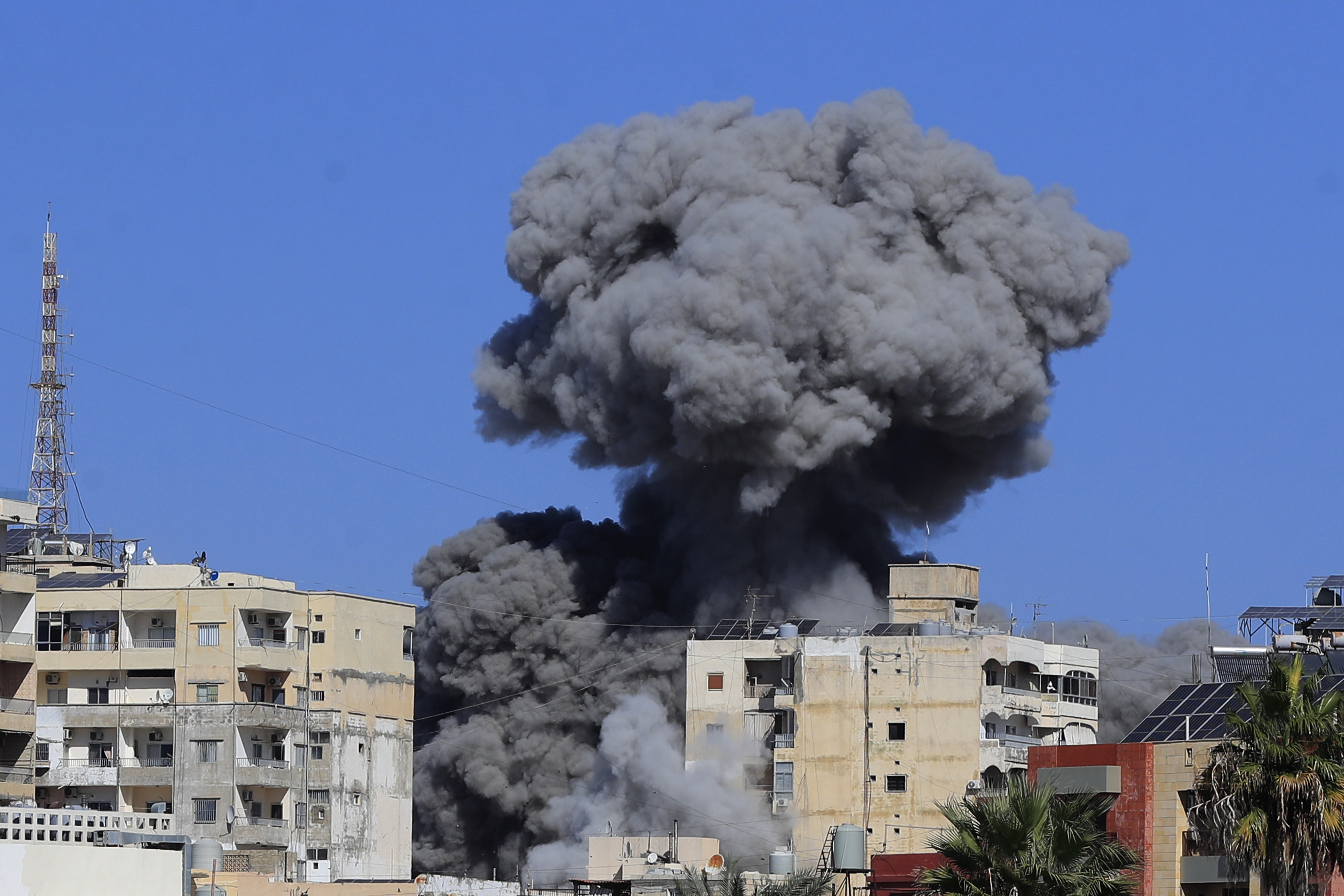 Smoke rises from buildings hit in an Israeli airstrike in Tyre, Lebanon, Wednesday, Oct. 23, 2024. (AP Photo/Mohammad Zaatari)