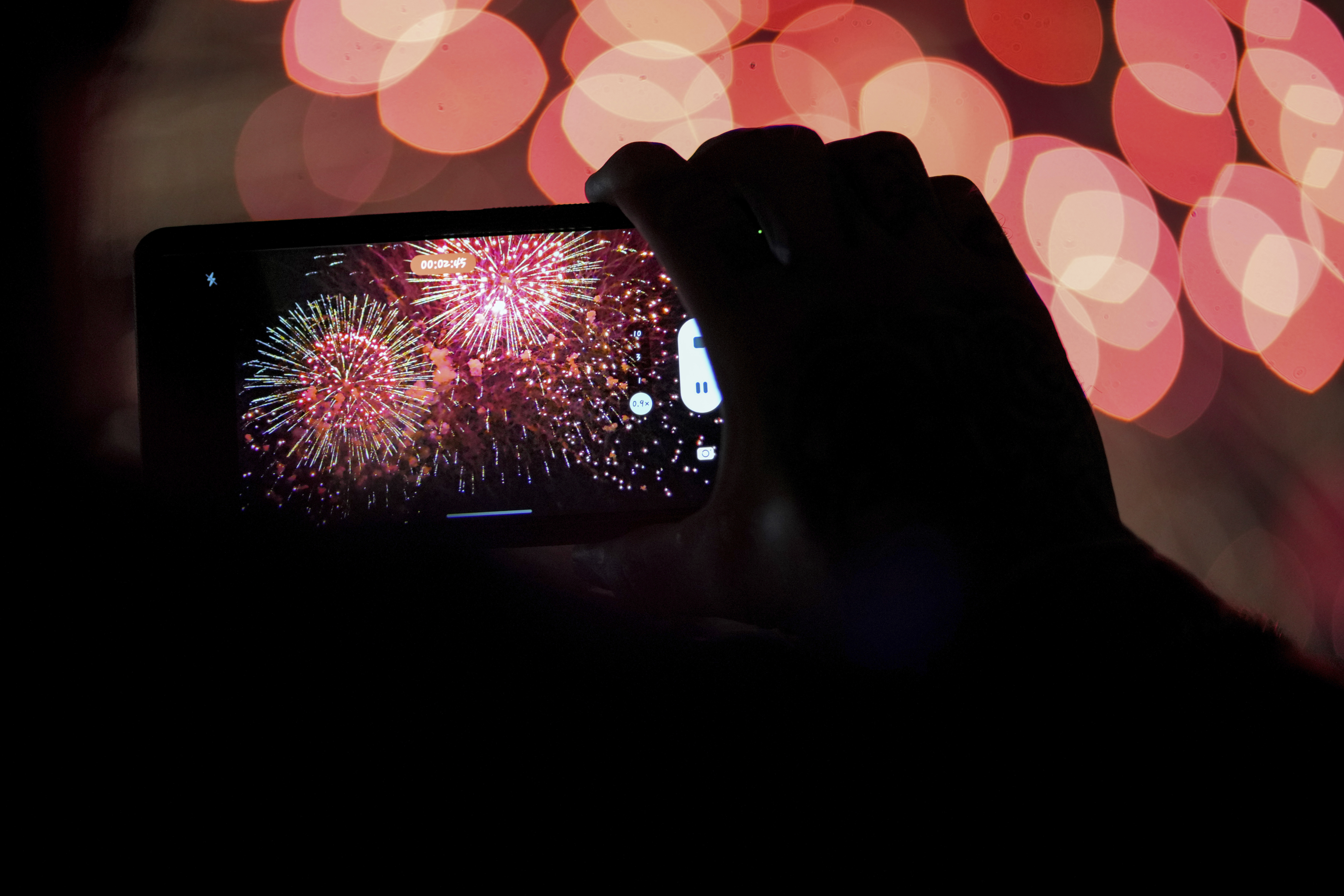 FILE - A spectator records a cell phone video as fireworks are launched over the Ohio River during the Western & Southern WEBN Fireworks show in Cincinnati on Sept. 3, 2023, in Cincinnati. (AP Photo/Aaron Doster)