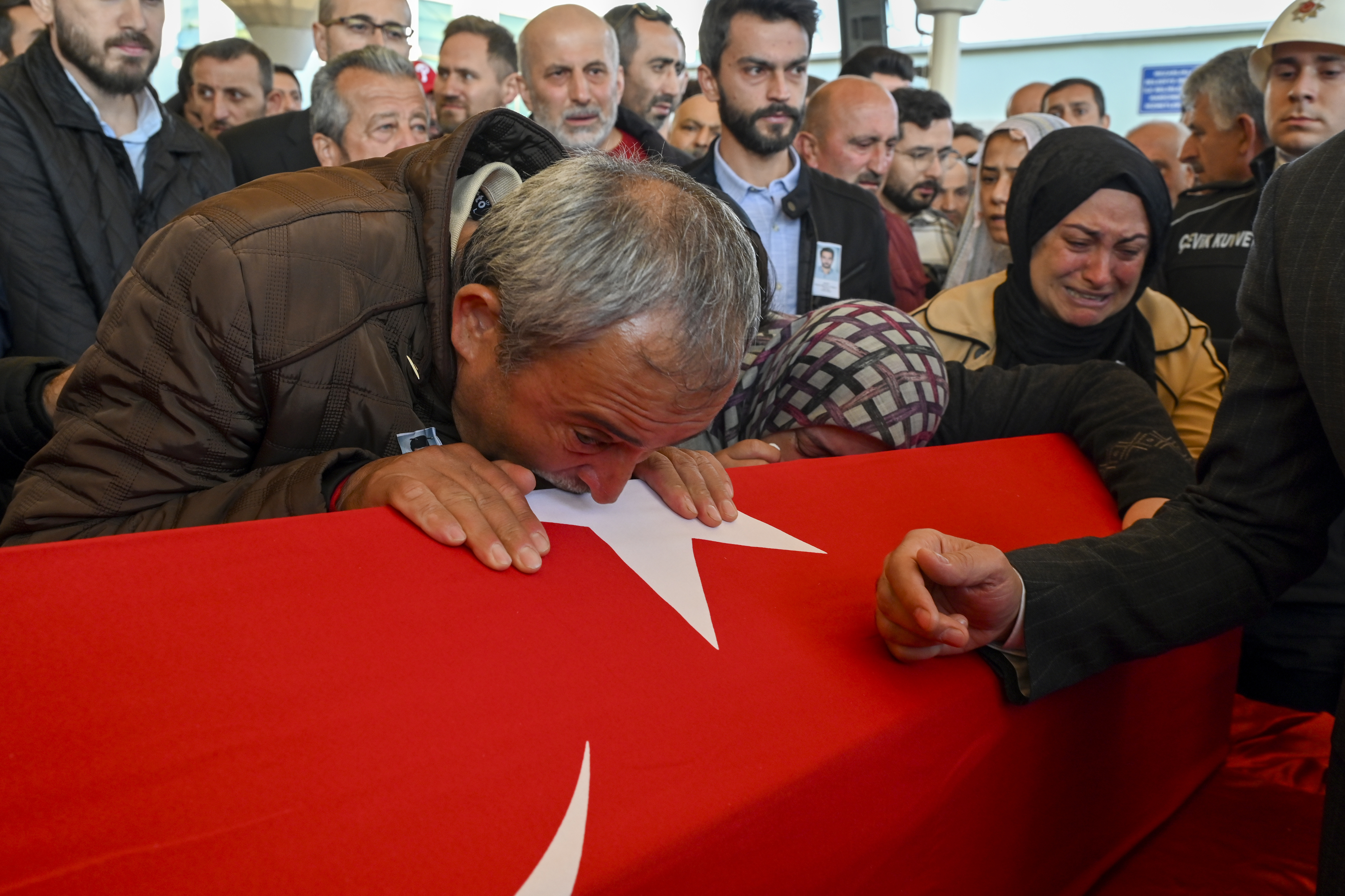 Relatives of Hasan Huseyin Canbaz, who was killed during an attack by PKK members at the Turkish aerospace and defense company TUSAS in Ankara on Wednesday, mourn during a funeral at Karsiyaka mosque in Ankara, Thursday, Oct. 24, 2024. (AP Photo/Ali Unal)