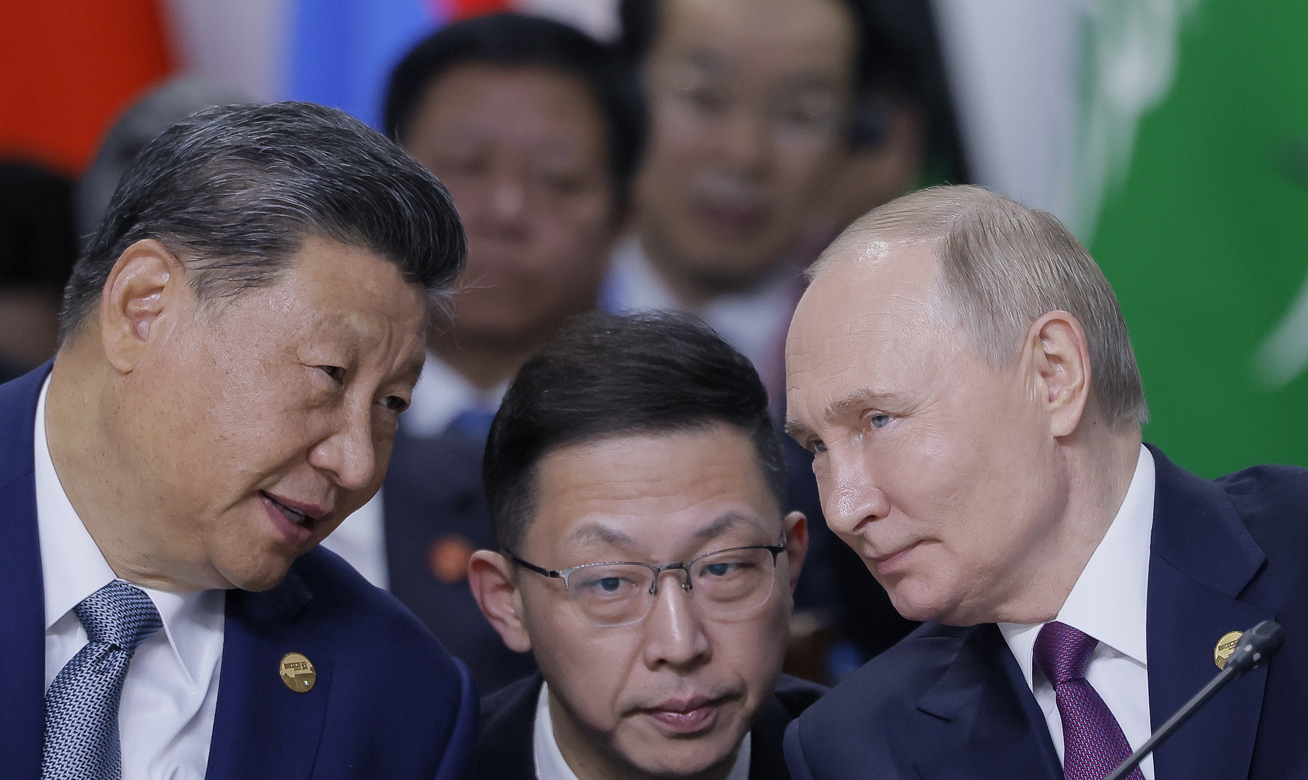 Chinese President Xi Jinping, left, and Russian President Vladimir Putin, right, speak during Outreach/BRICS Plus format session at BRICS Summit in Kazan, Russia, Thursday, Oct. 24, 2024. (Maxim Shemetov, Pool Photo via AP)