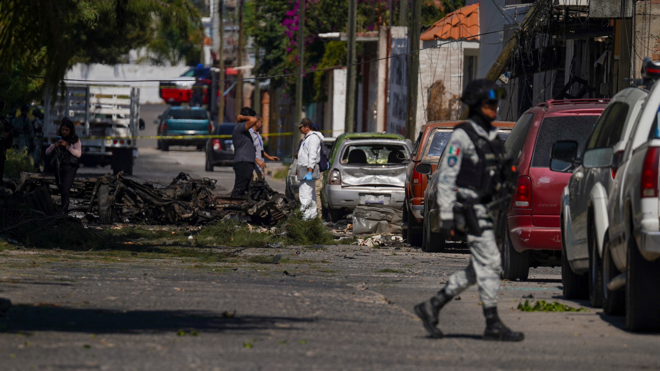 Security agents and experts on the scene where a car bomb exploded near a police station, in Acambaro, Guanajuato state, Mexico, Thursday, Oct. 24, 2024. (AP Photo/Armando Solis)