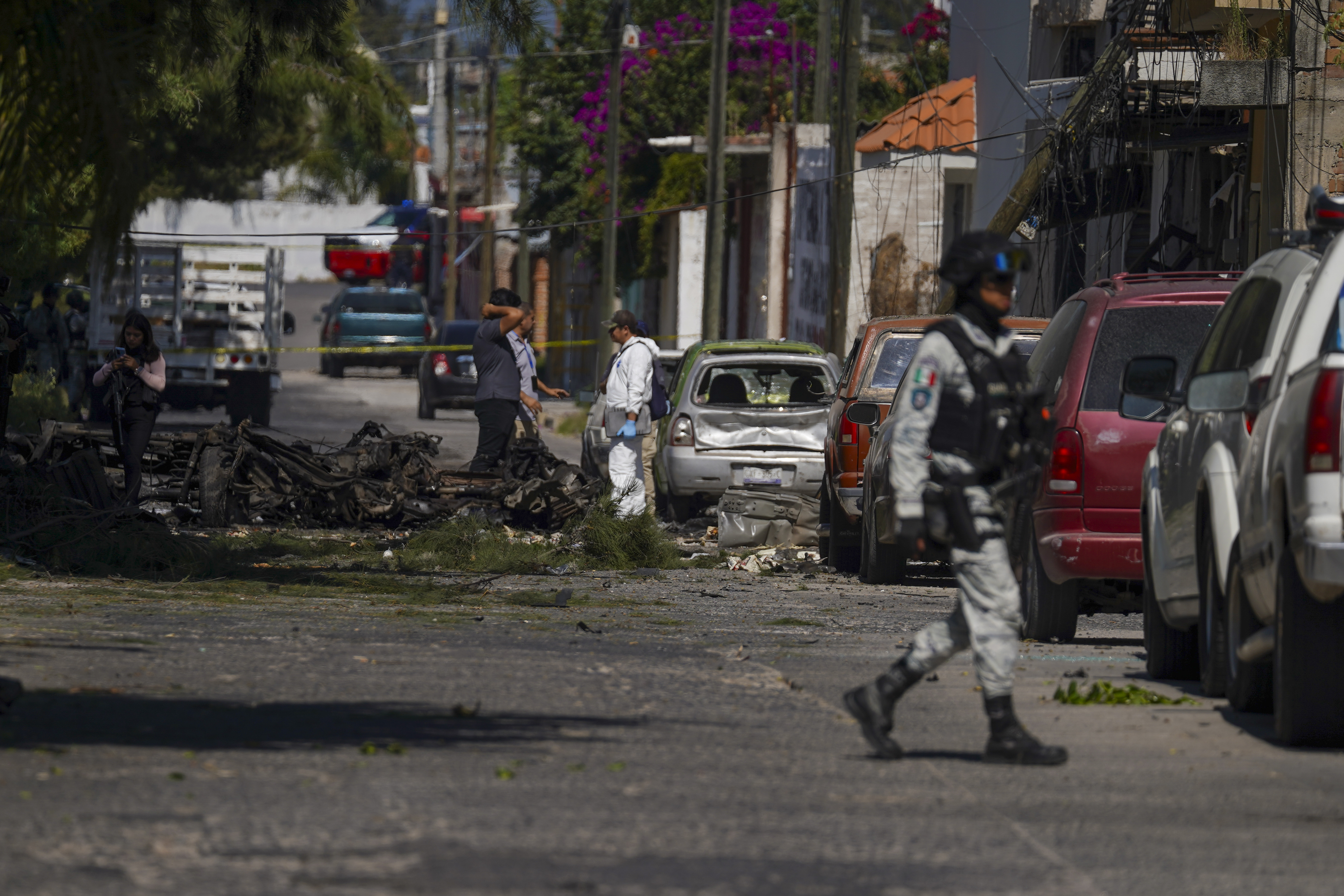 Security agents and experts on the scene where a car bomb exploded near a police station, in Acambaro, Guanajuato state, Mexico, Thursday, Oct. 24, 2024. (AP Photo/Armando Solis)