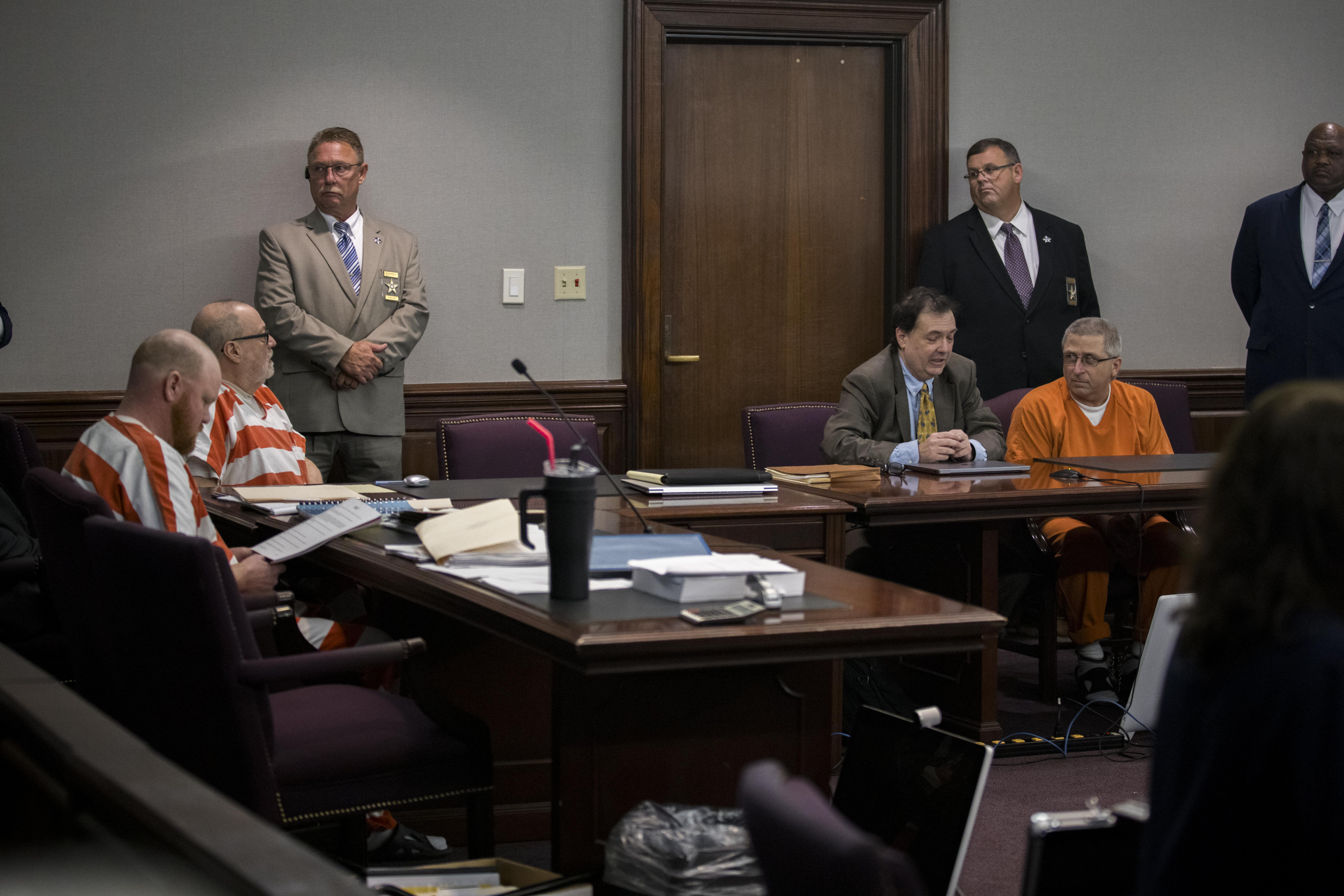 Travis McMichael, left, Greg McMichael, second from the left, and William "Roddie" Bryan, far right, sit at the defense table during a a hearing for a new trial, Thursday, Oct. 24, 2024, in Brunswick, Ga. (AP Photo/Stephen B. Morton)