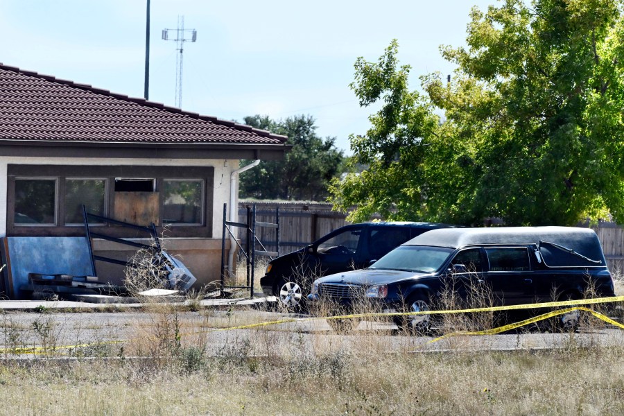 FILE - A hearse and debris can be seen at the rear of the Return to Nature Funeral Home, Oct. 5, 2023, in Penrose, Colo. (Jerilee Bennett/The Gazette via AP, File)