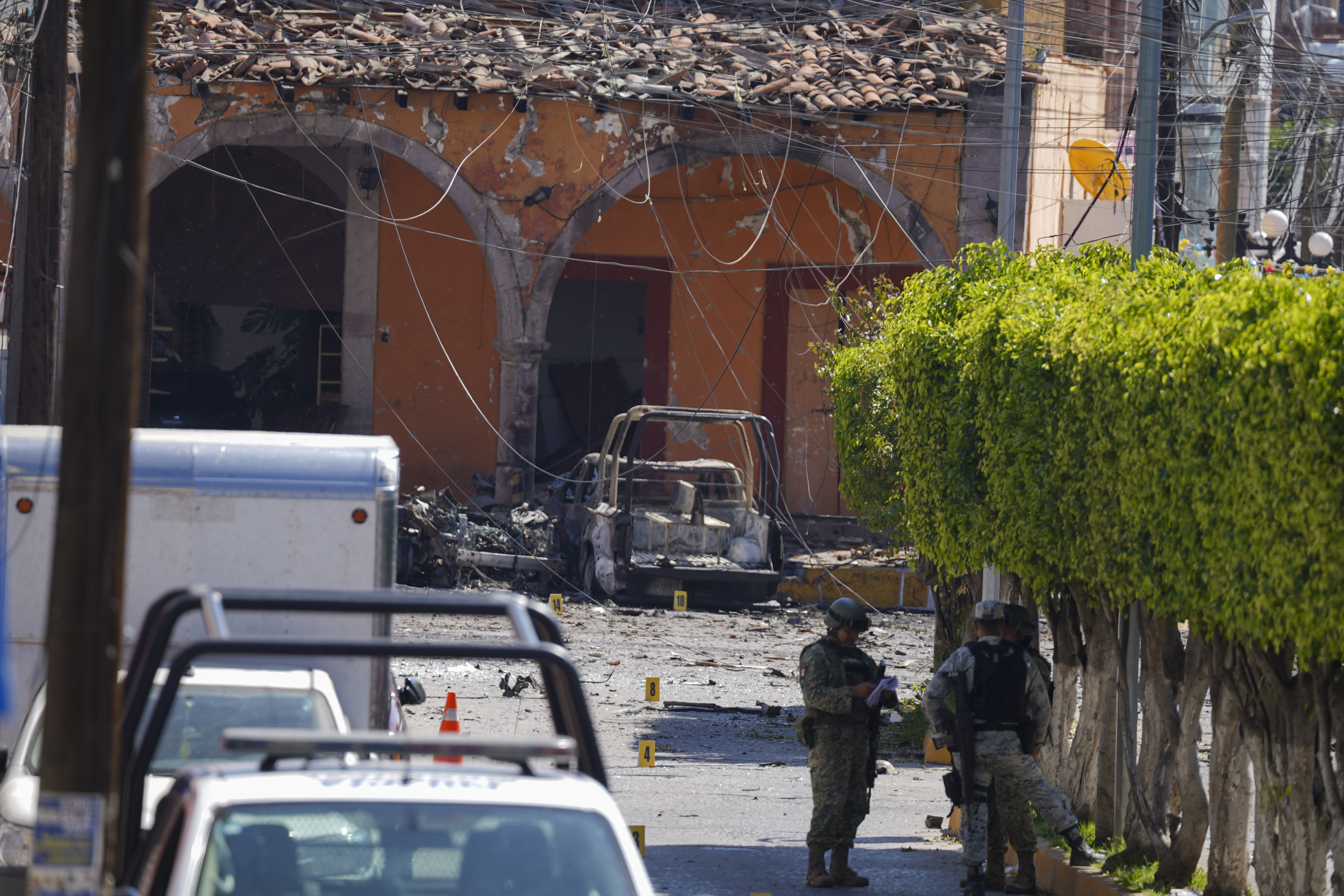 Law enforcement officers patrol the scene where a car bomb exploded near a police station, in Jerecuaro, Guanajuato state, Mexico, Thursday, Oct. 24, 2024. (AP Photo/Armando Solis)