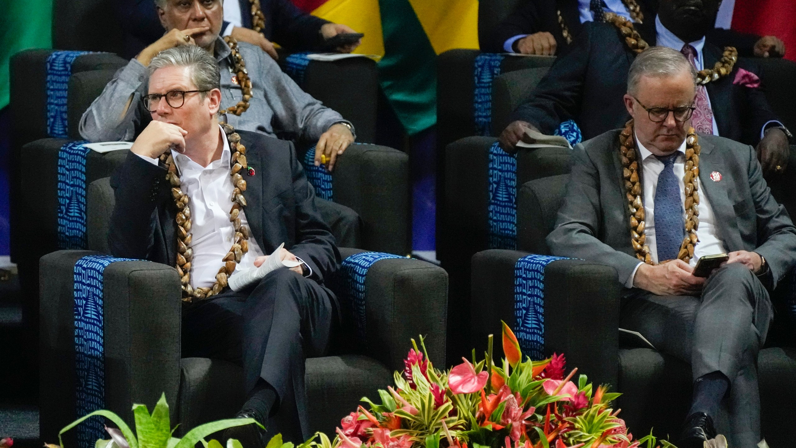 British Prime Minister Keir Starmer, left, and Australian Prime Minister Anthony Albanese react during the opening ceremony for the Commonwealth Heads of Government meeting in Apia, Samoa, Friday, Oct. 25, 2024. (AP Photo/Rick Rycroft/Pool)