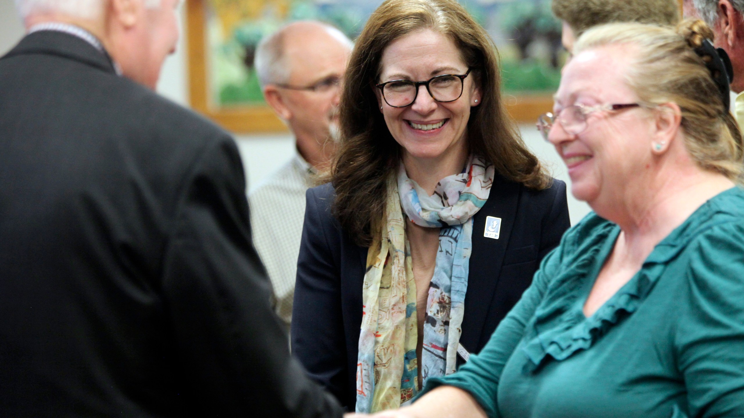 Kansas State Board of Education member Melanie Haas, center, D-Overland Park, watches as the winner of a national competition for school bus drivers is congratulated during a break in the board's regular monthly meeting, Wednesday, Oct. 9, 2024, in Topeka, Kan. (AP Photo/John Hanna)