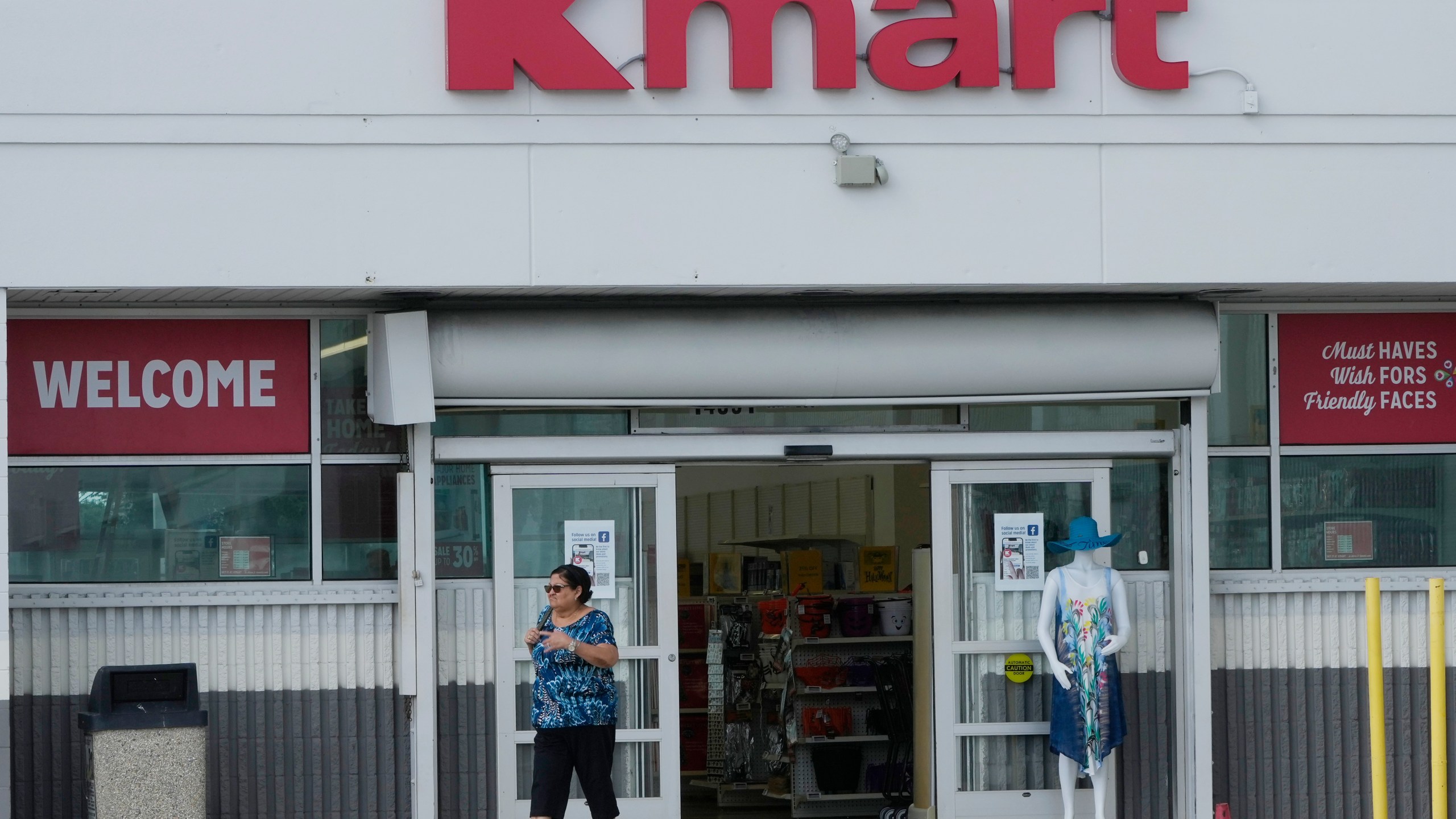 A customer exits the only Kmart store left in the continental United States, Tuesday, Oct. 22, 2024, in Miami. (AP Photo/Marta Lavandier)