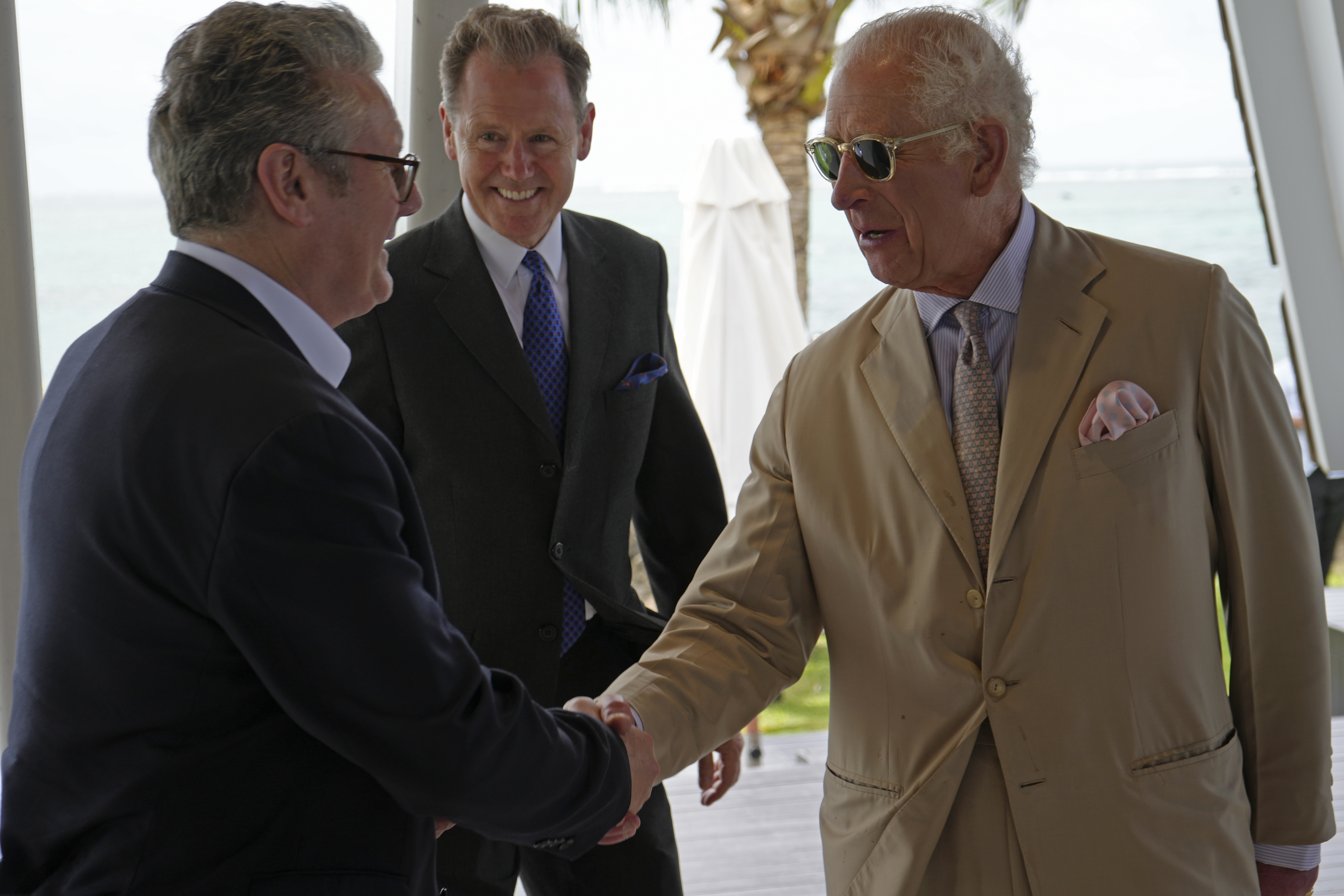 Britain's King Charles III, right, shakes hands with Britain's Prime Minister Keir Starmer at a reception the King is hosting for for heads of government and spouses/partners attending the Commonwealth Heads of Government Meeting (CHOGM) in Apia, Samoa, on Friday, Oct. 25, 2024. (Samoa CHOGM 2024/Pool Photo via AP)