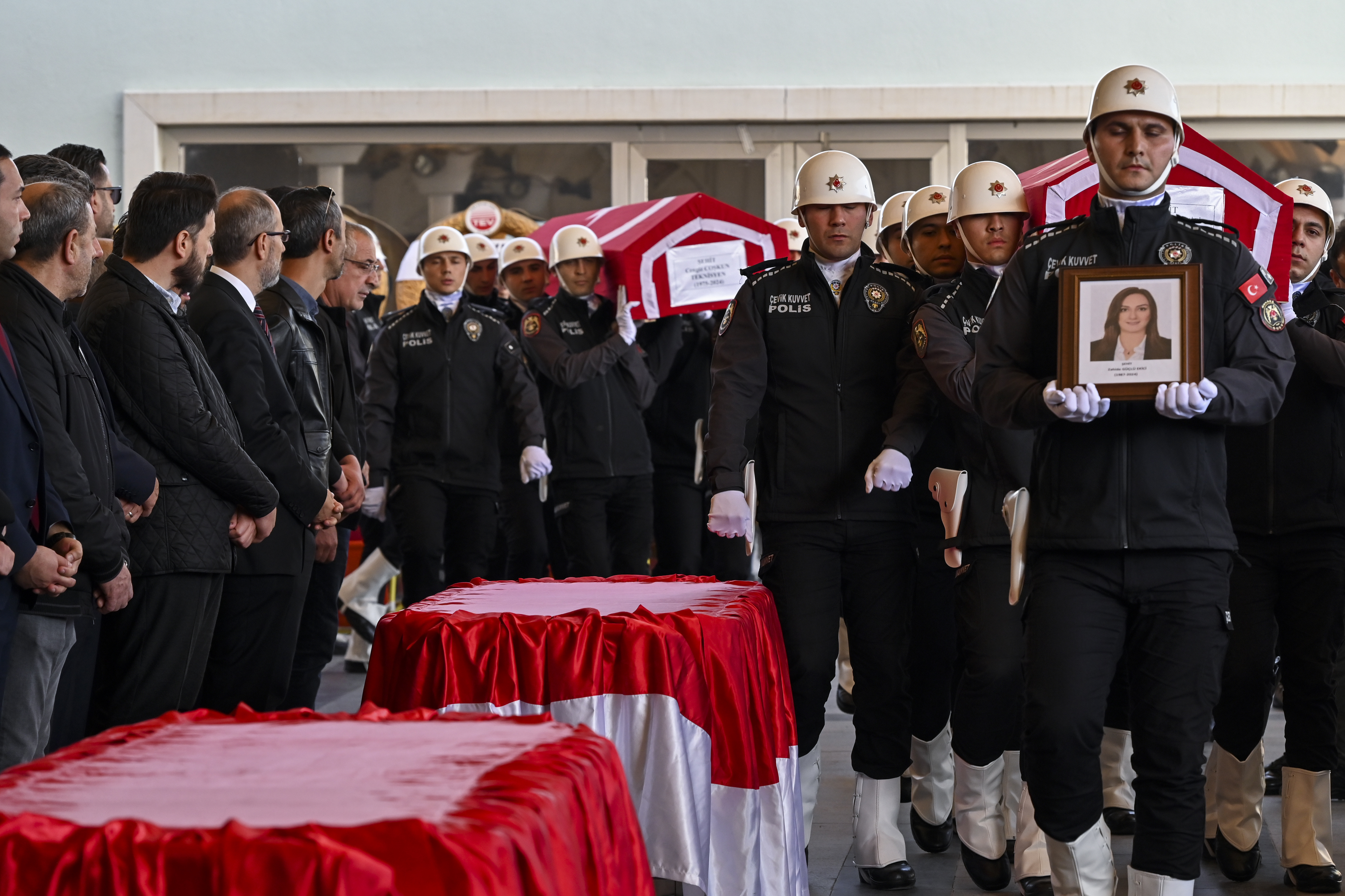 Turkish soldiers carry the coffins of Zahide Guglu Ekici, Hasan Huseyin Canbaz and Cengiz Coskun during their funeral at Karsiyaka mosgue in Ankara, Thursday, Oct. 24, 2024, a day after they were killed during an attack by PKK members at the Turkish aerospace and defense company TUSAS on Wednesday. (AP Photo/Ali Unal)