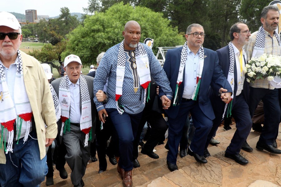 FILE - Nelson Mandela's grandson Mandla Mandela, center, with Hamas official Basem Naim, center right, during a march to commemorate the 10th anniversary of the death of former South African president Nelson Mandela in Pretoria, South Africa, Tuesday, Dec. 5, 2023. (AP Photo, File)