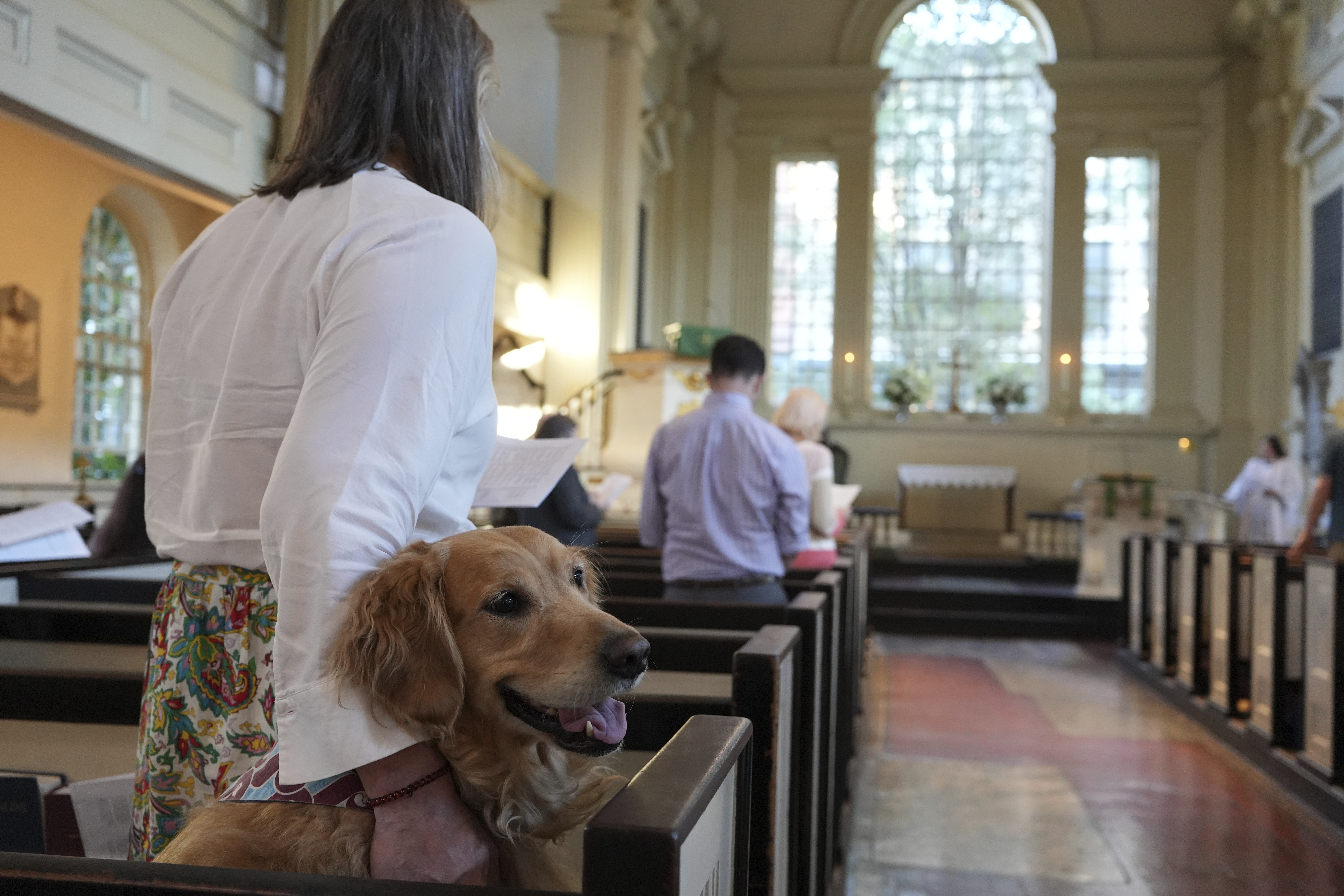 Madeline Tess Farmer and her golden retriever dog, Wrigley, join a Blessing of the Animals ceremony in honor of St. Francis at Philadelphia’s Christ Church on Sunday, Oct. 6, 2024. (AP Photo/Luis Andres Henao)