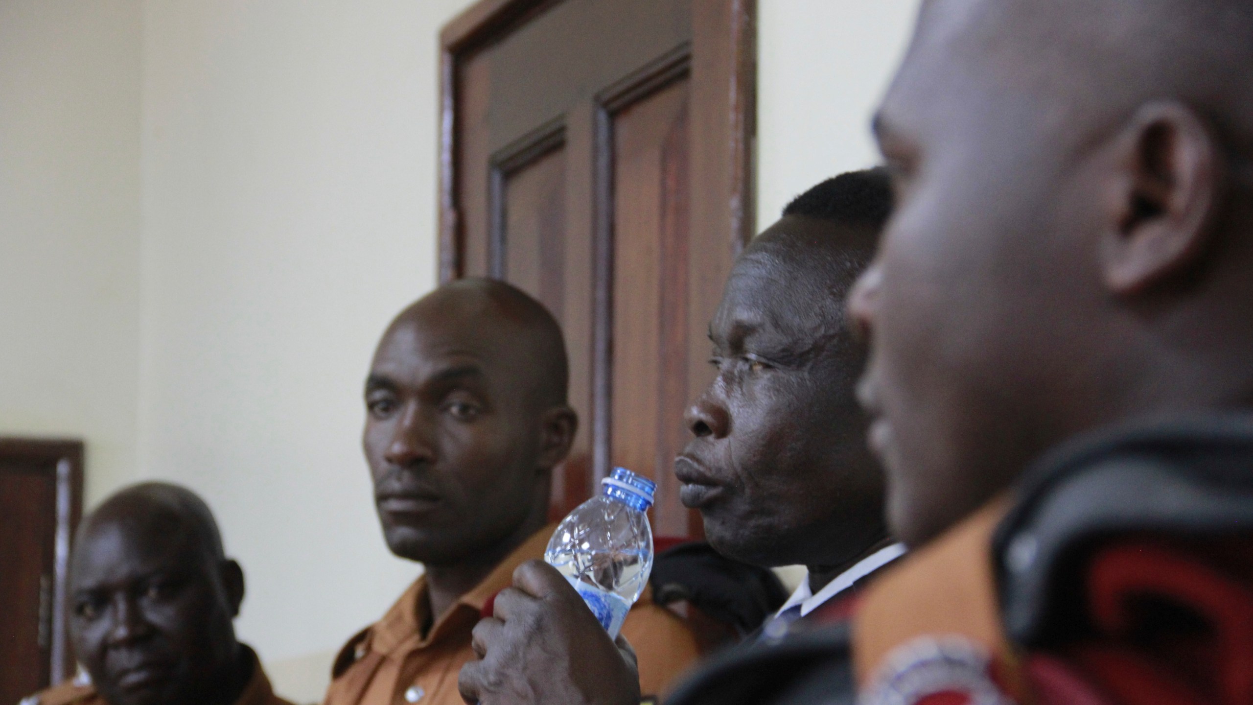 Former commander of the Lord's Resistance Army rebel Thomas Kwoyelo, drinks water as he listens to the court ruling in Gulu, Uganda Friday, Sept. 25, 2024. (AP Photo)