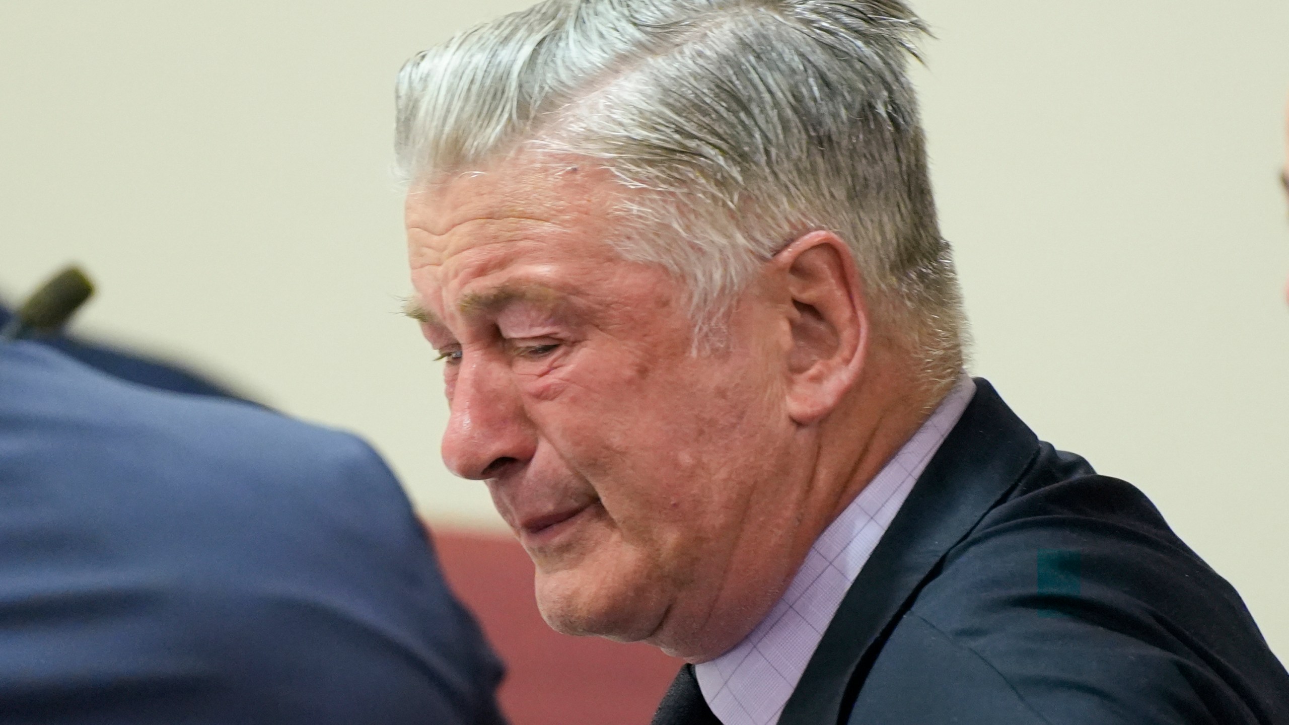 FILE - Actor Alec Baldwin, center, reacts as he sits between his attorneys Alex Spiro, left, and Luke Nikas after the judge threw out the involuntary manslaughter case for the 2021 fatal shooting of cinematographer Halyna Hutchins during filming of the Western movie "Rust," Friday, July 12, 2024, in Santa Fe, N.M. (Ramsay de Give/Pool Photo via AP, File)